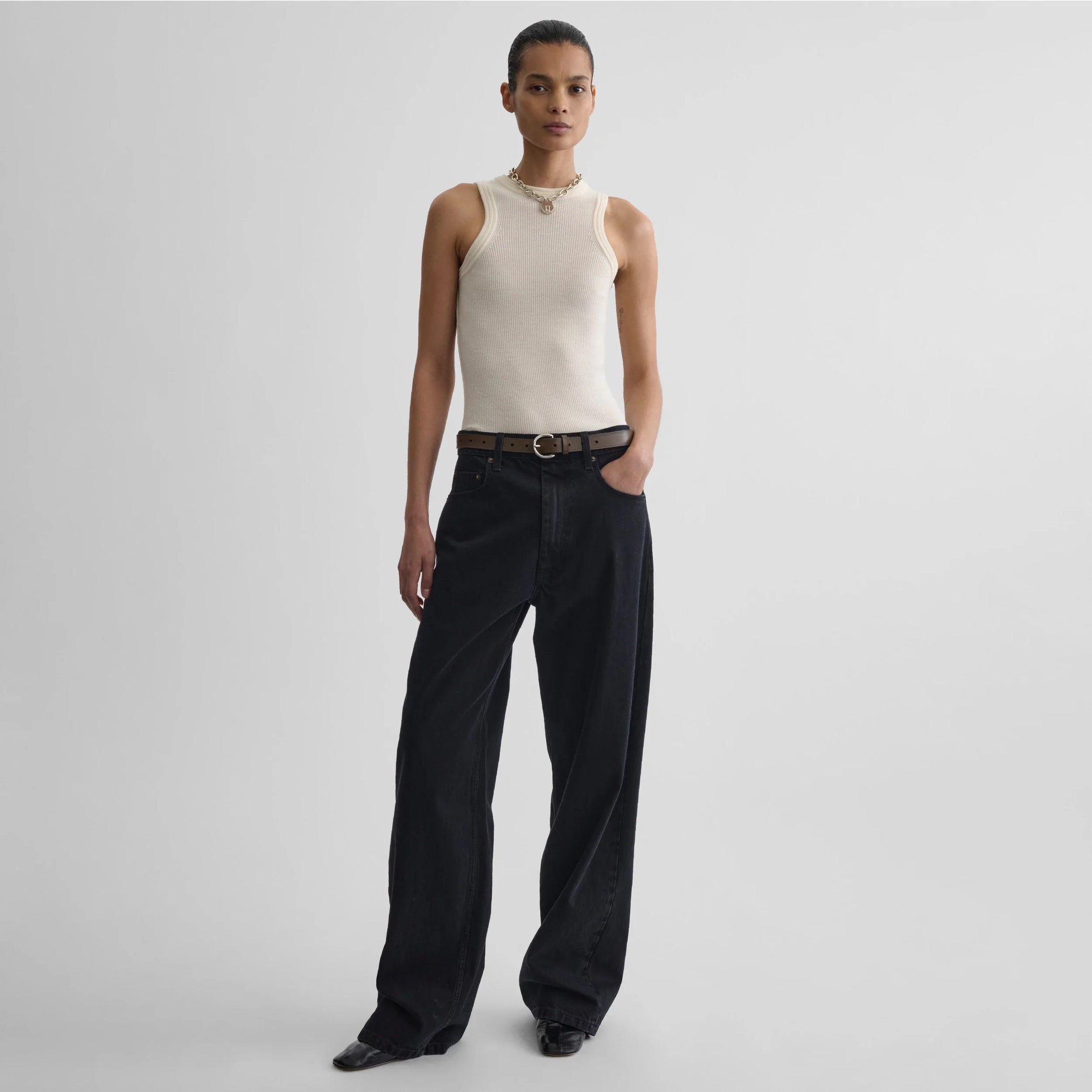 Front view model wearing light merino wool rib tank top in cream