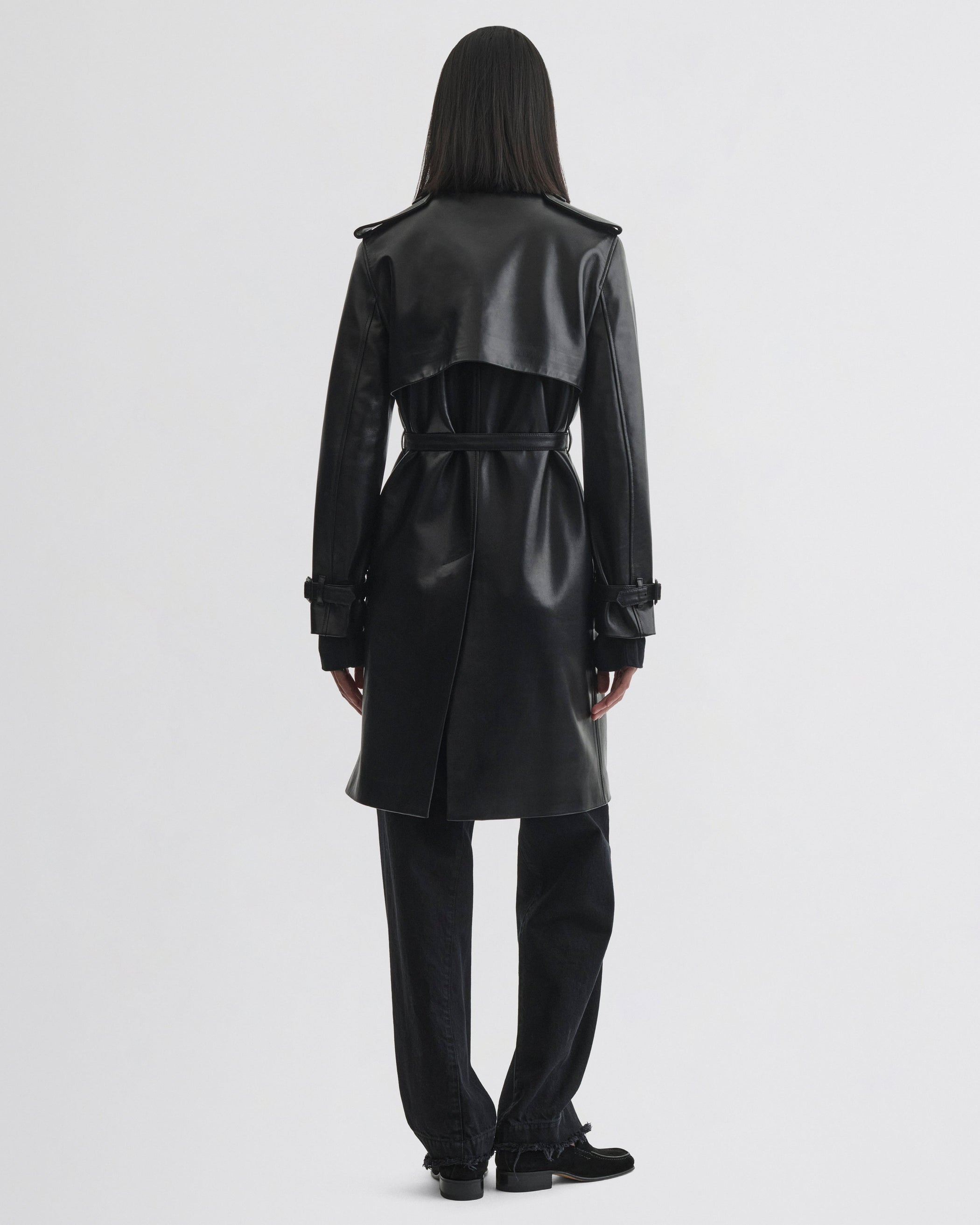 Back view of model wearing Short Trench in black leather