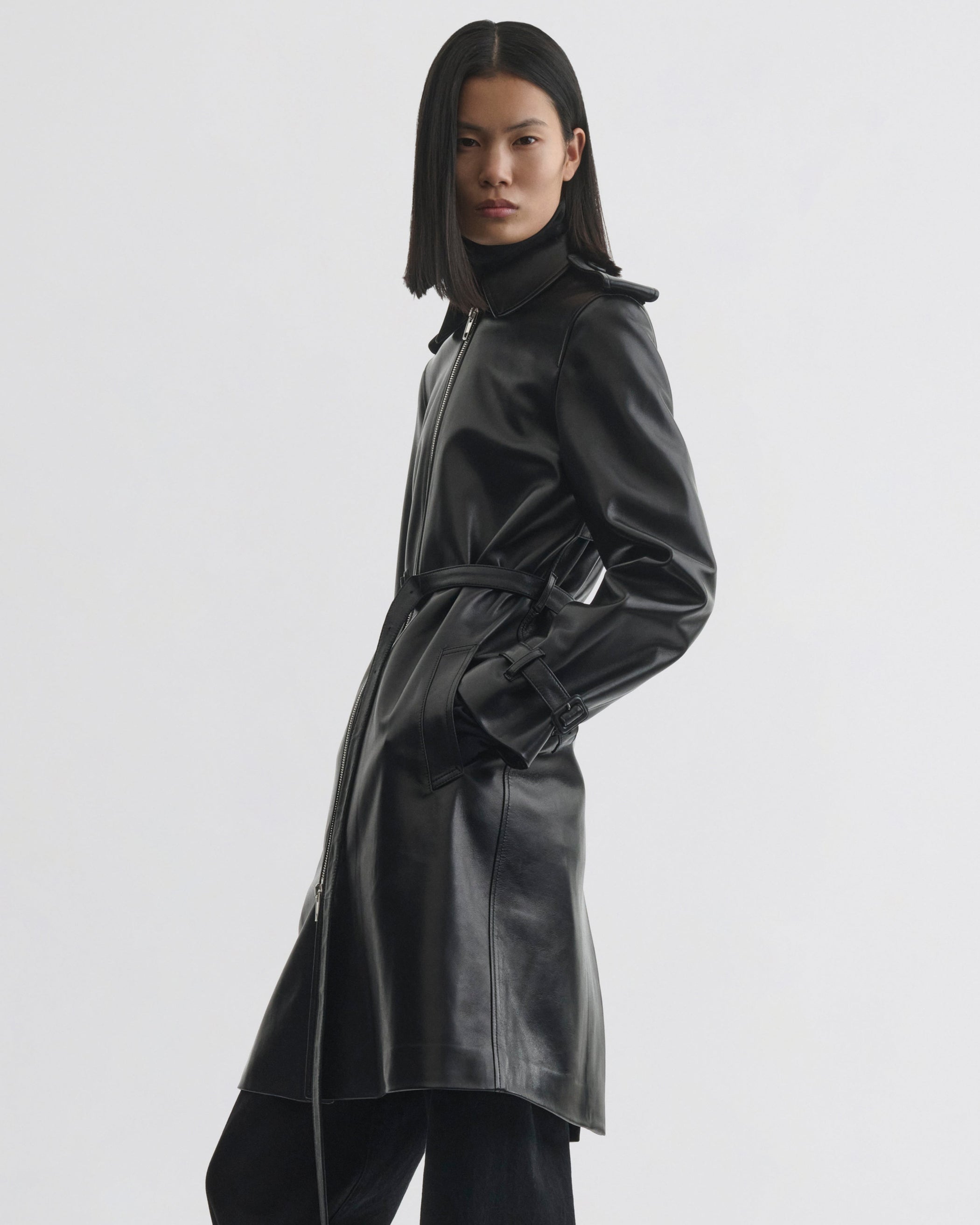 Side view of model wearing Short Trench in black leather