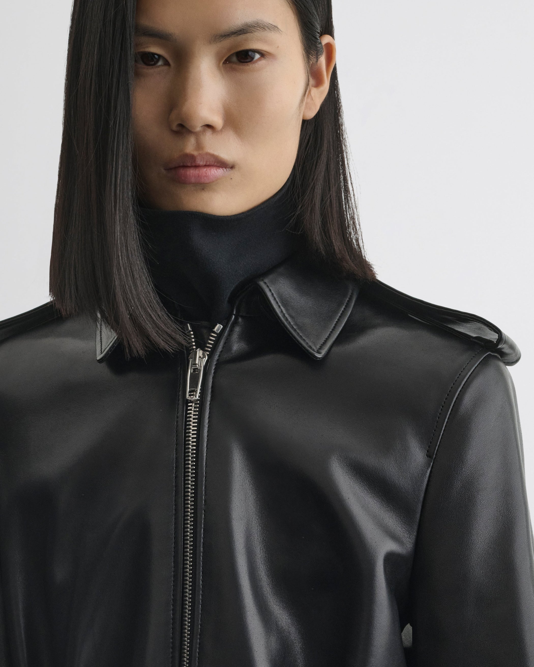 Close up detail view of Short Trench in black leather
