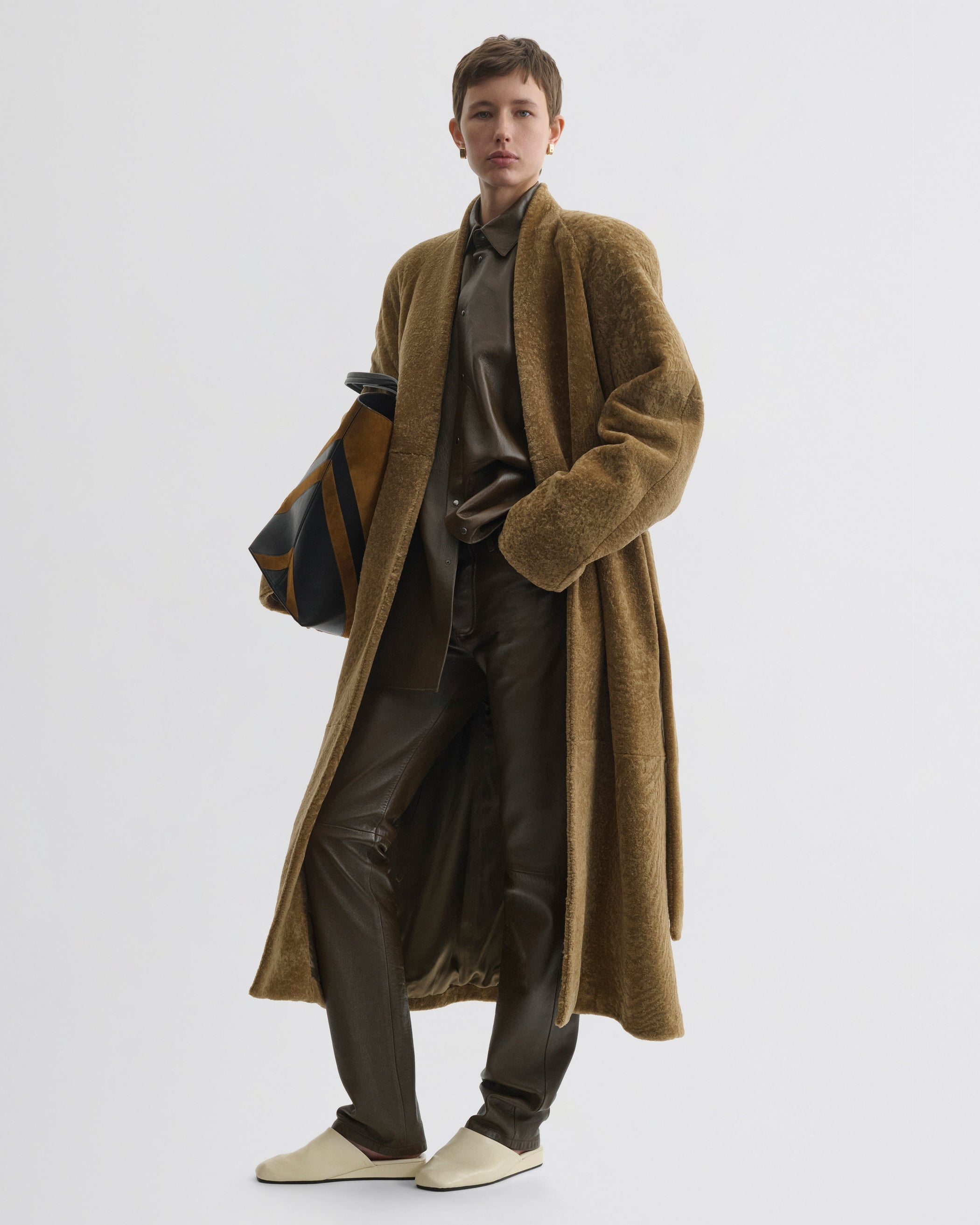 Front view of model wearing Shaved Robe Coat in tabac shearling