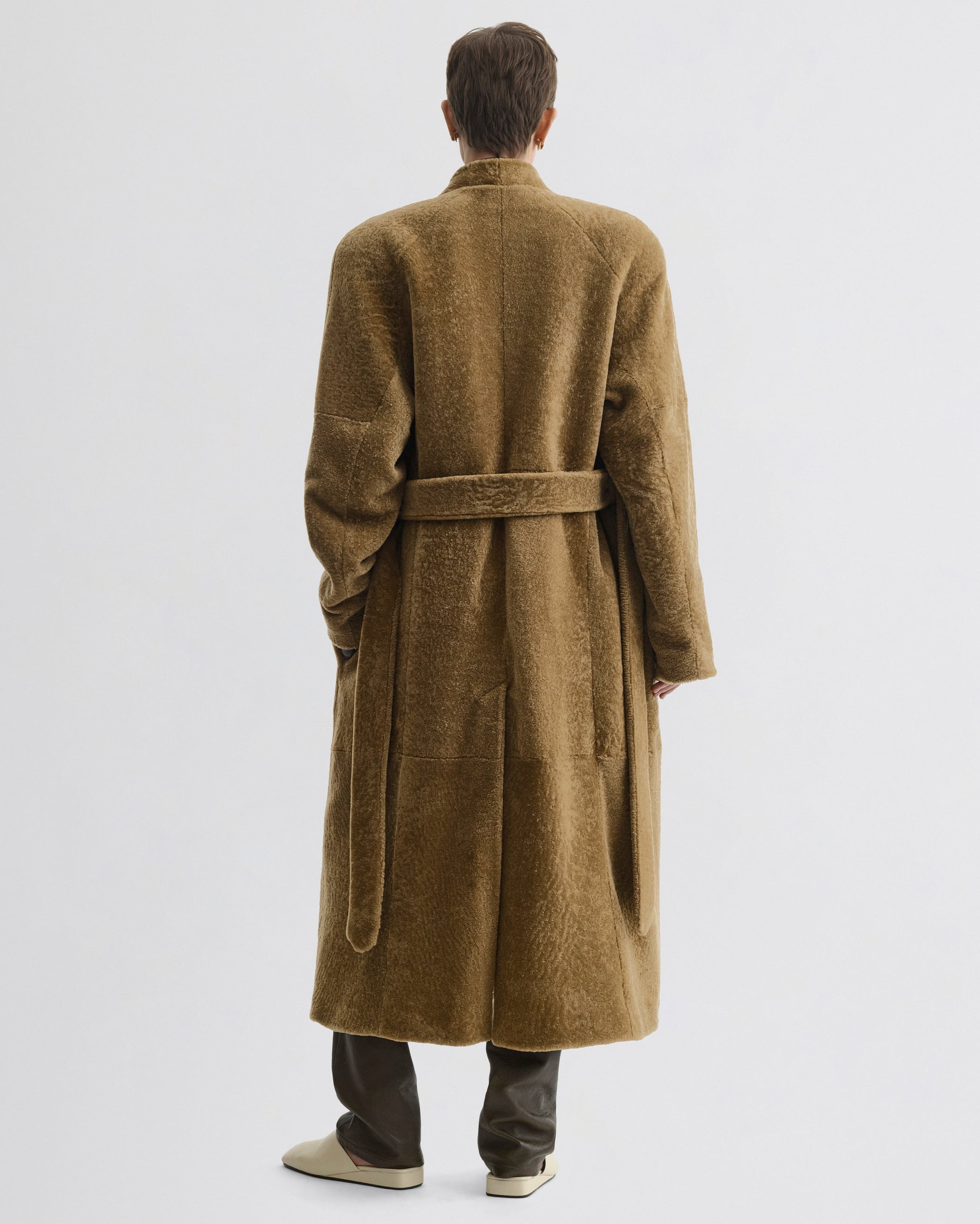 Back view of model wearing Shaved Robe Coat in tabac shearling