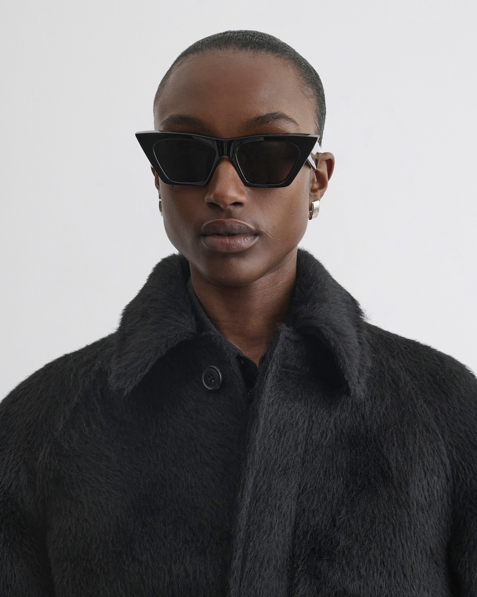 Close up view of model wearing Cropped Car Coat in black alpaca wool