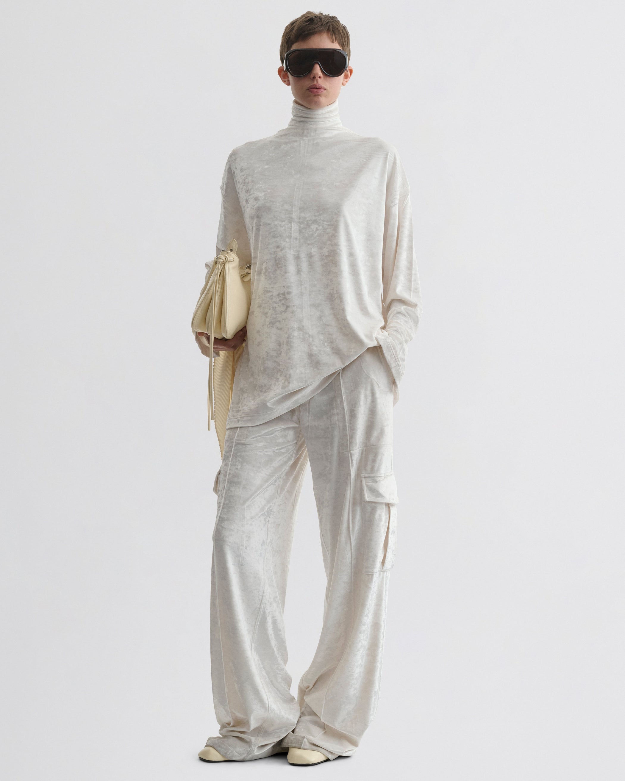 Front view of model wearing LIQUID CARGO TROUSERS  in white crushed velvet