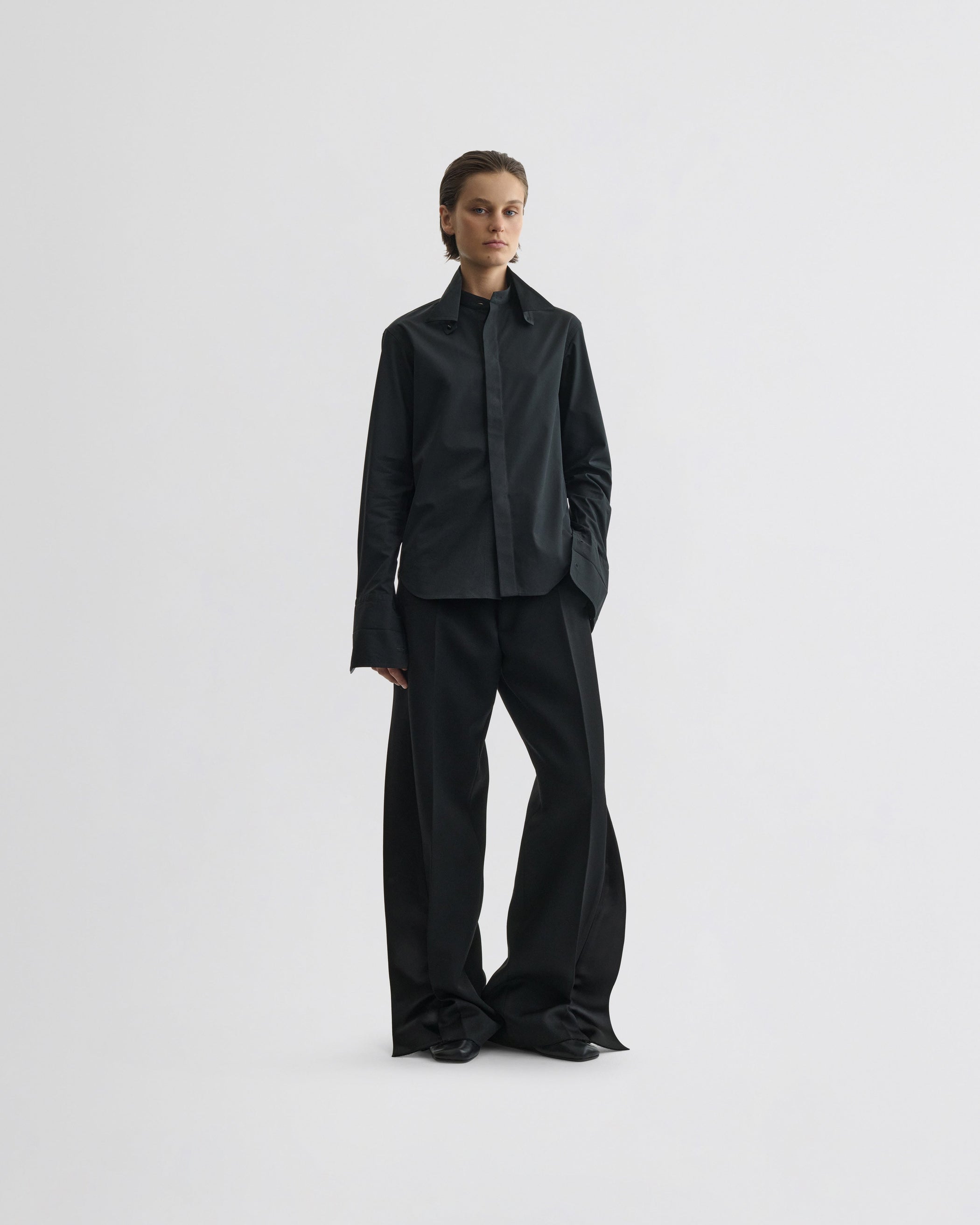 View of split tux trousers in black wool