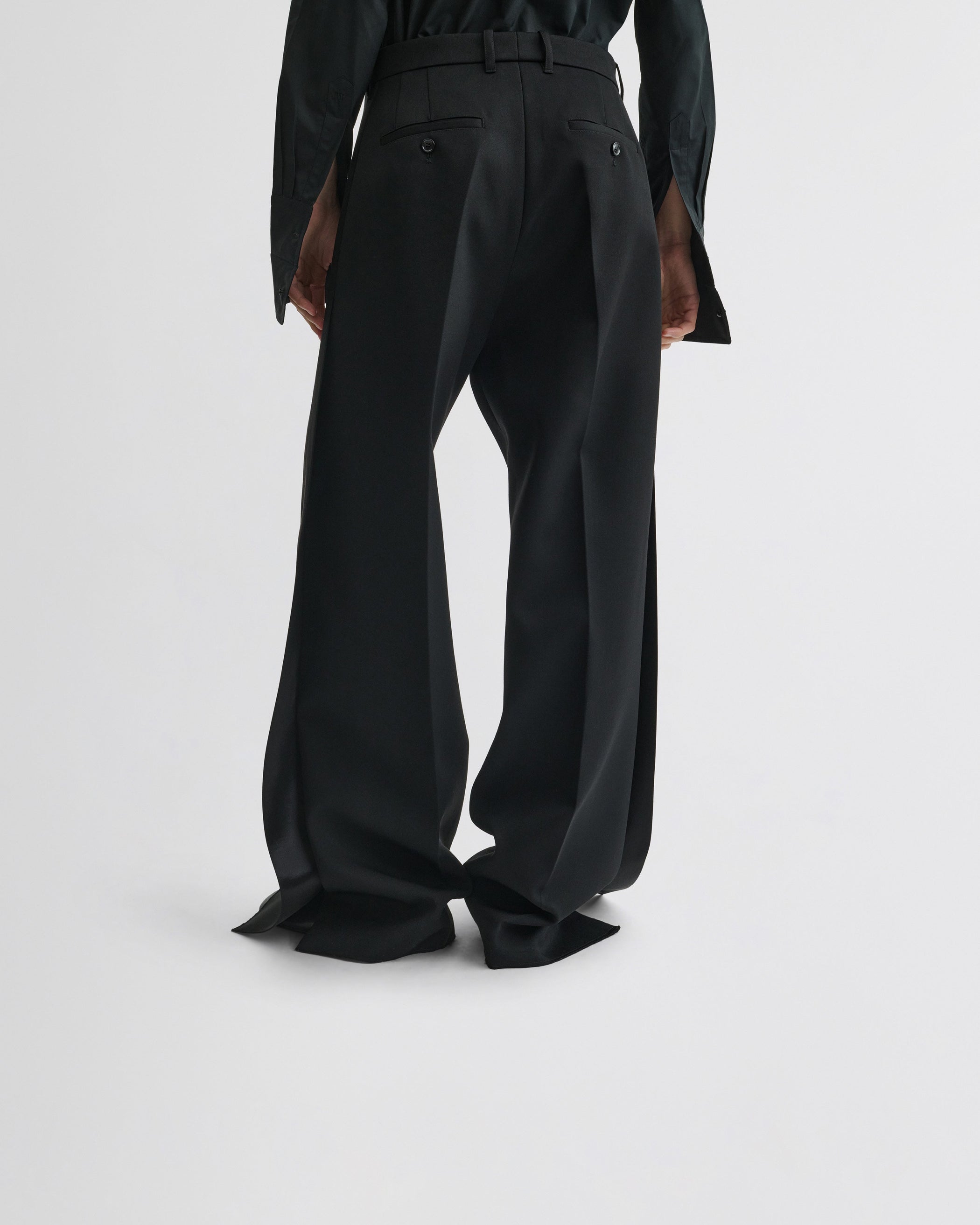 View of split tux trousers in black wool