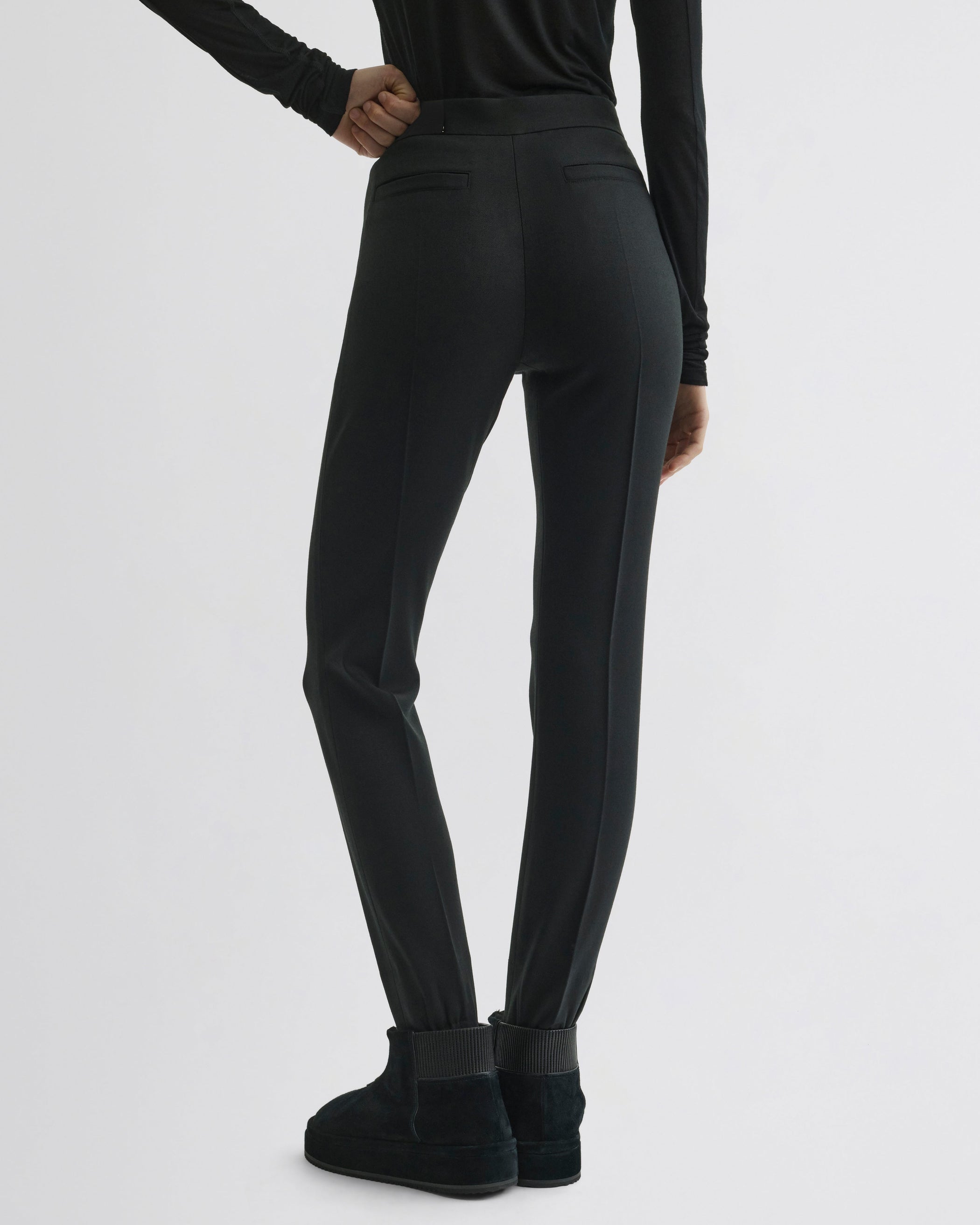 Back view of Stirrup Trousers in black wool