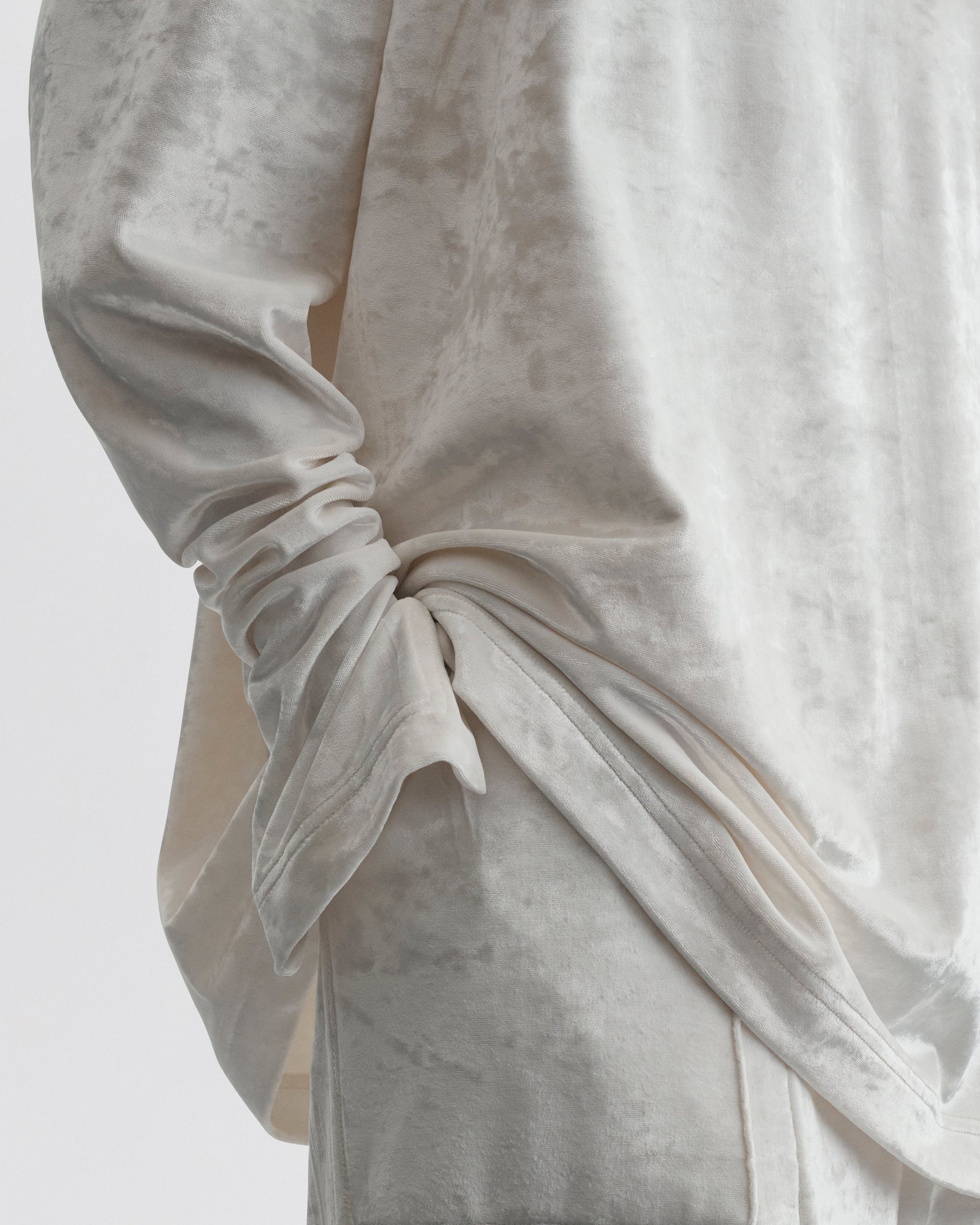 Close up detail view of LIQUID HIGH NECK TOP in white crushed velvet