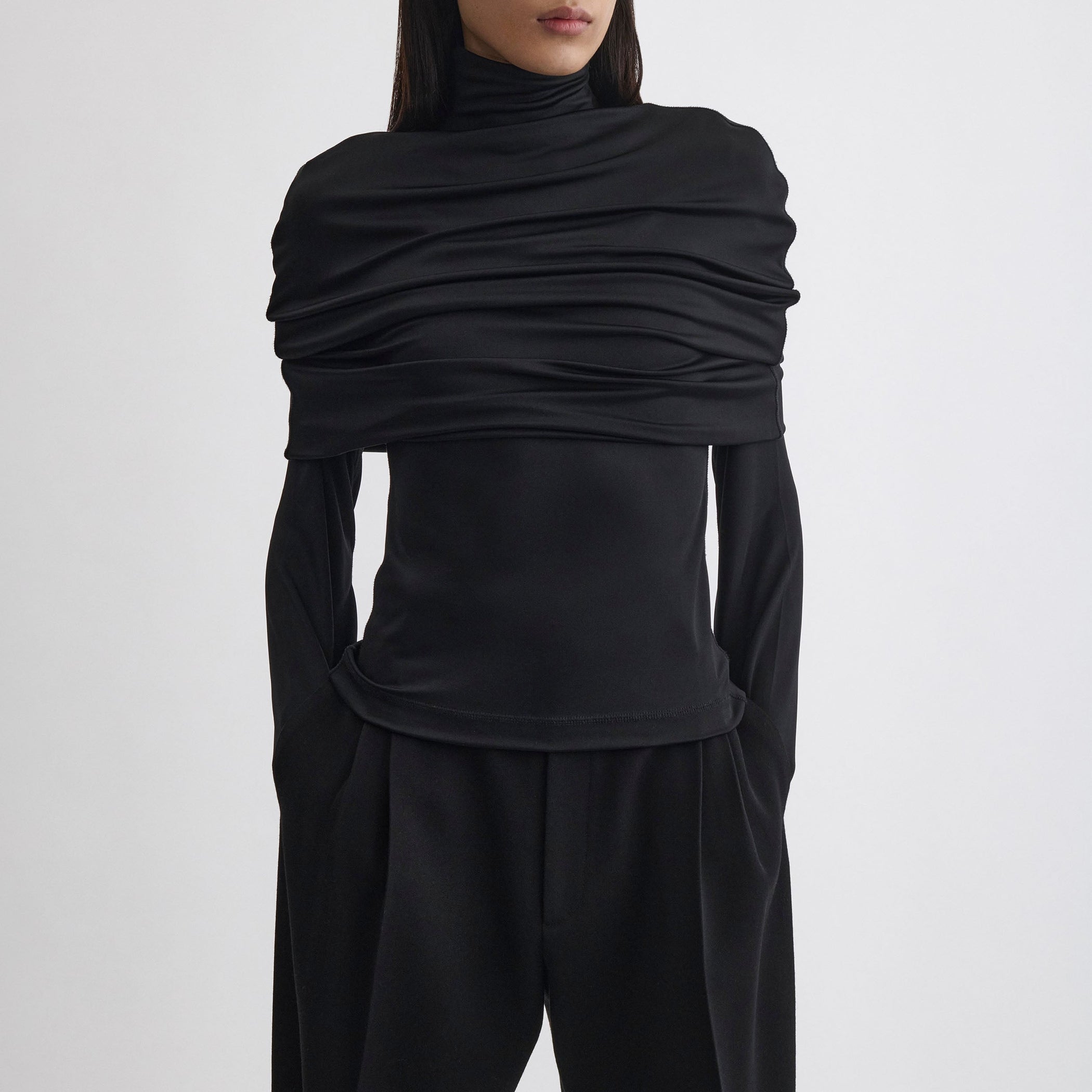 Front view of model wearing CAPE TOP in black viscose