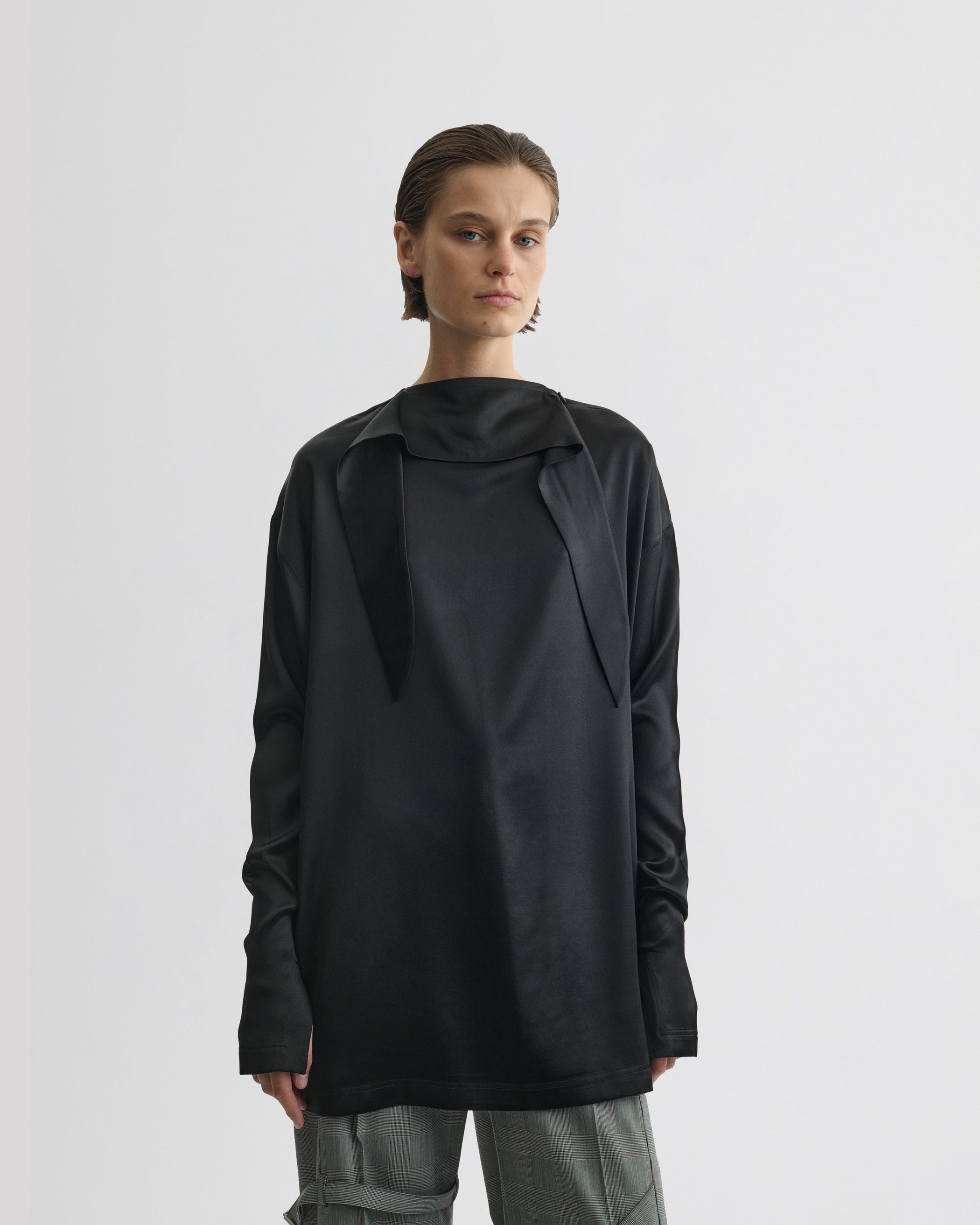 Front view of model wearing LIQUID KNOT COLLAR TOP in black silk