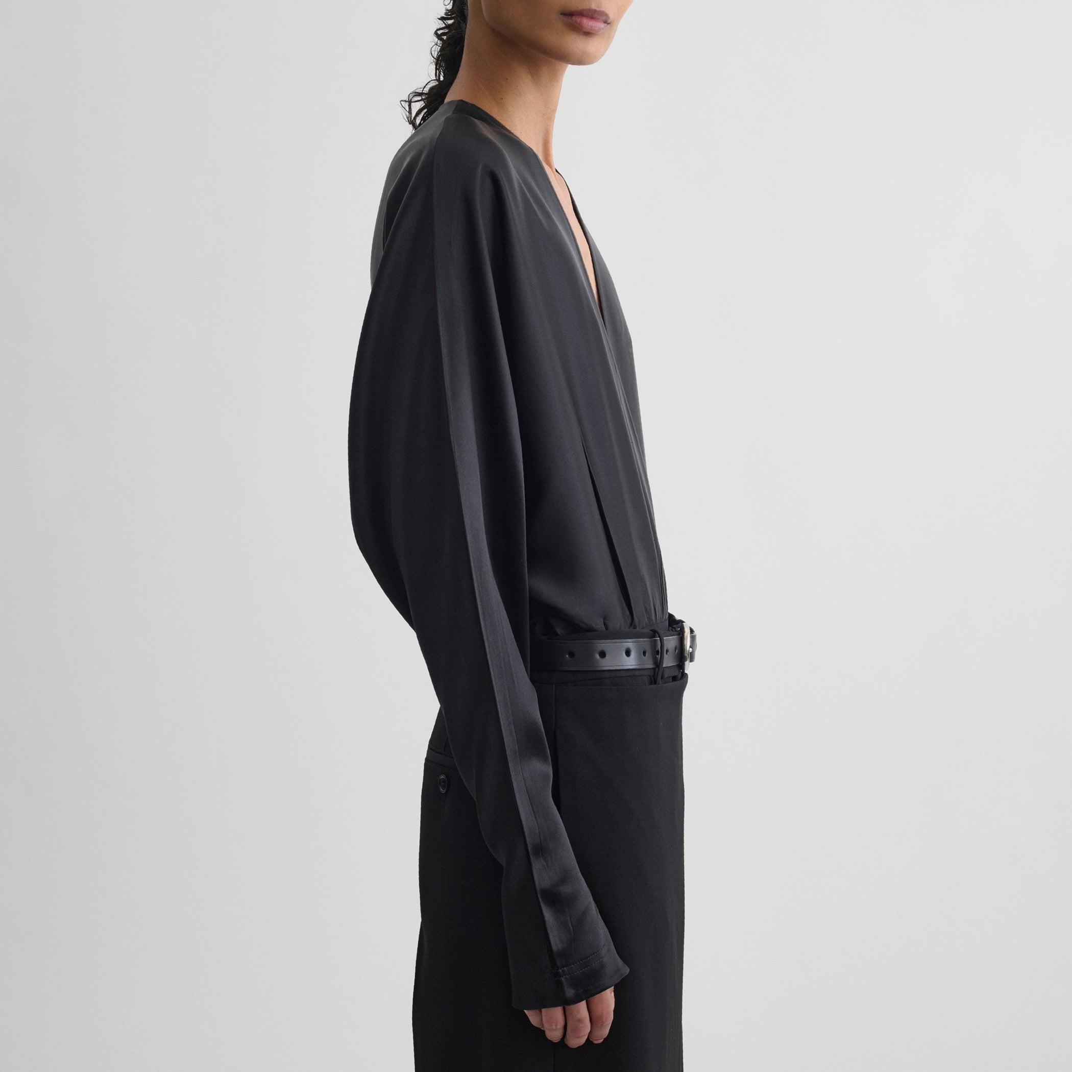 Side view of model wearing BATWING BODY in black silk satin