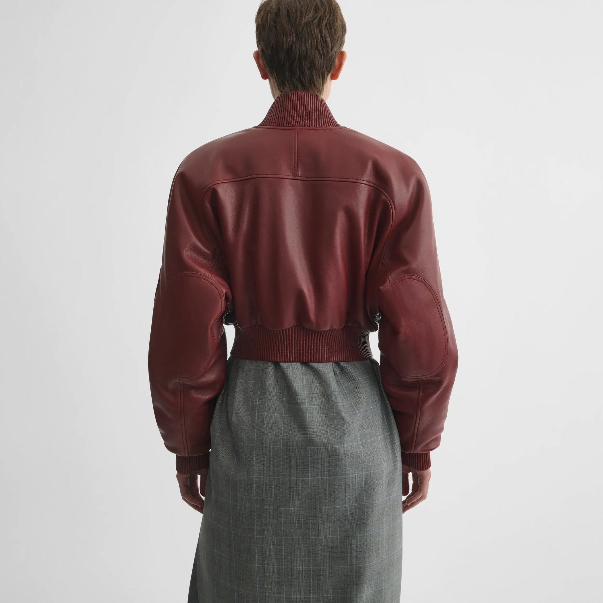 Back view of pocket bomber jacket in brick leather