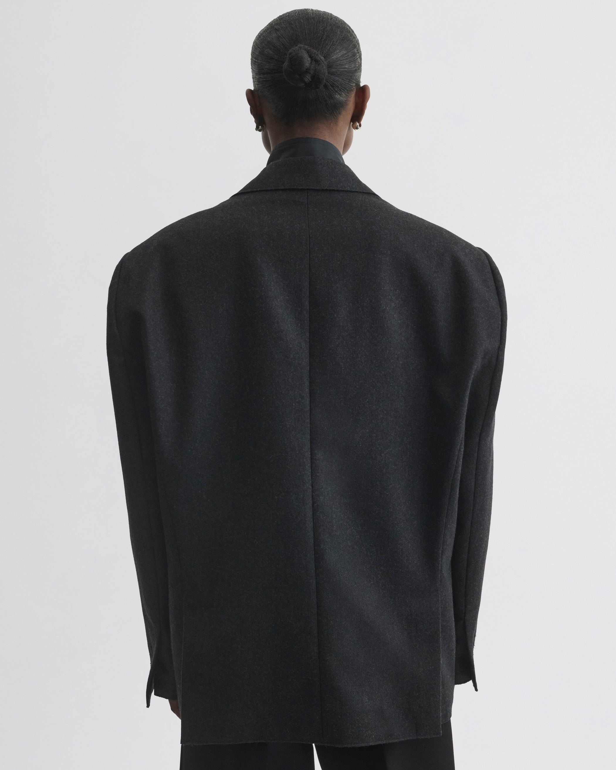 Back view of model wearing Tuxedo Jacket in anthracite wool
