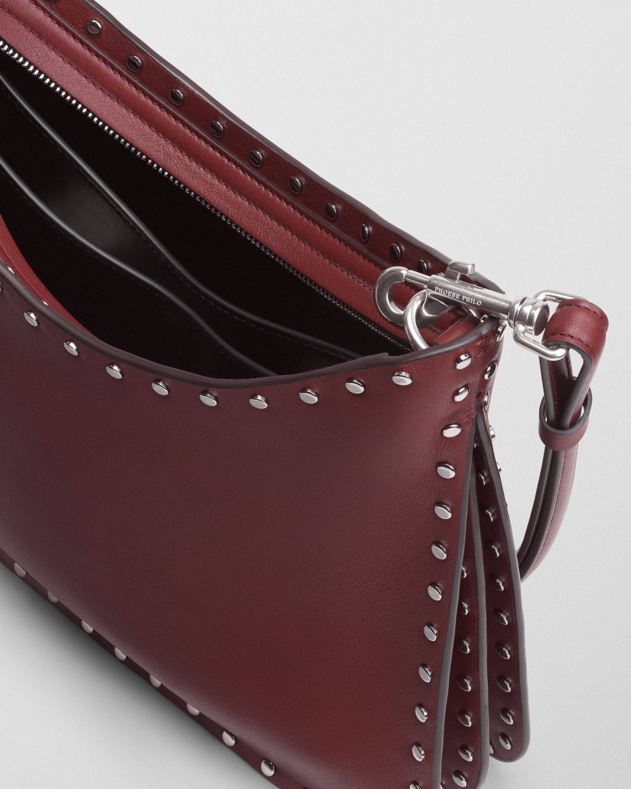 Close up detail view of SMALL STUD GIG BAG in chestnut leather