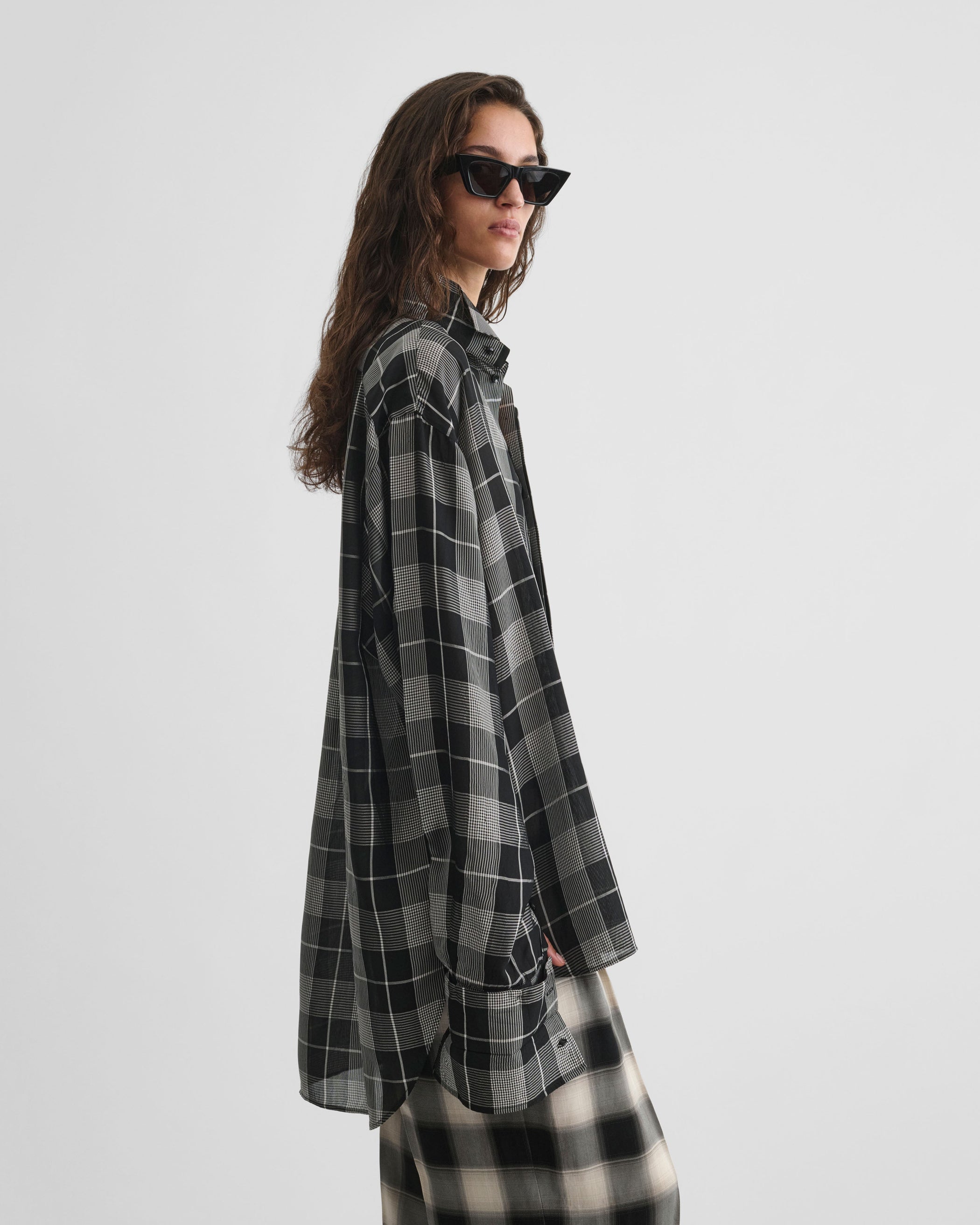 Side view of model wearing CUSTOM TUX SHIRT in b/w check viscose