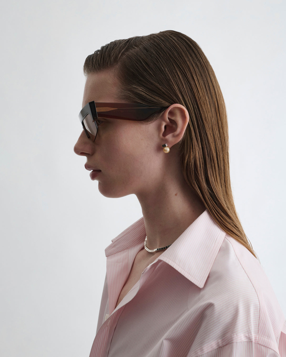 Side view of model wearing SLICED CRUISE SUNGLASSES in chestnut acetate