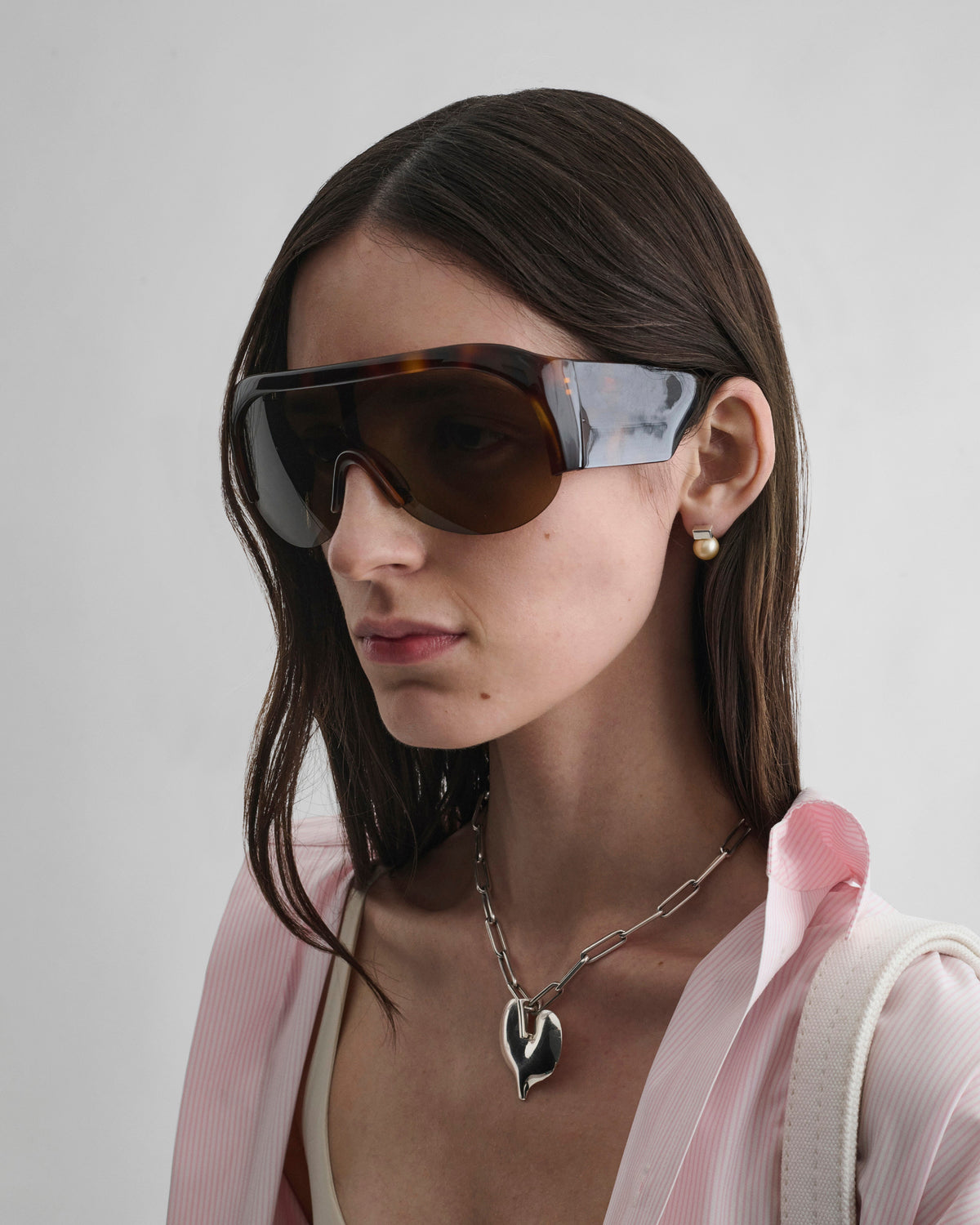 Front view of model wearing HALF BOMBÉ SUNGLASSES in cognac tortoiseshell acetate