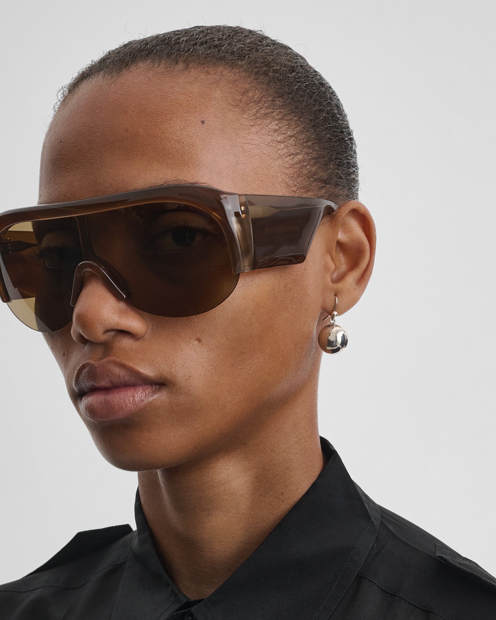 Front view of model wearing SPHERE EARRINGS in silver