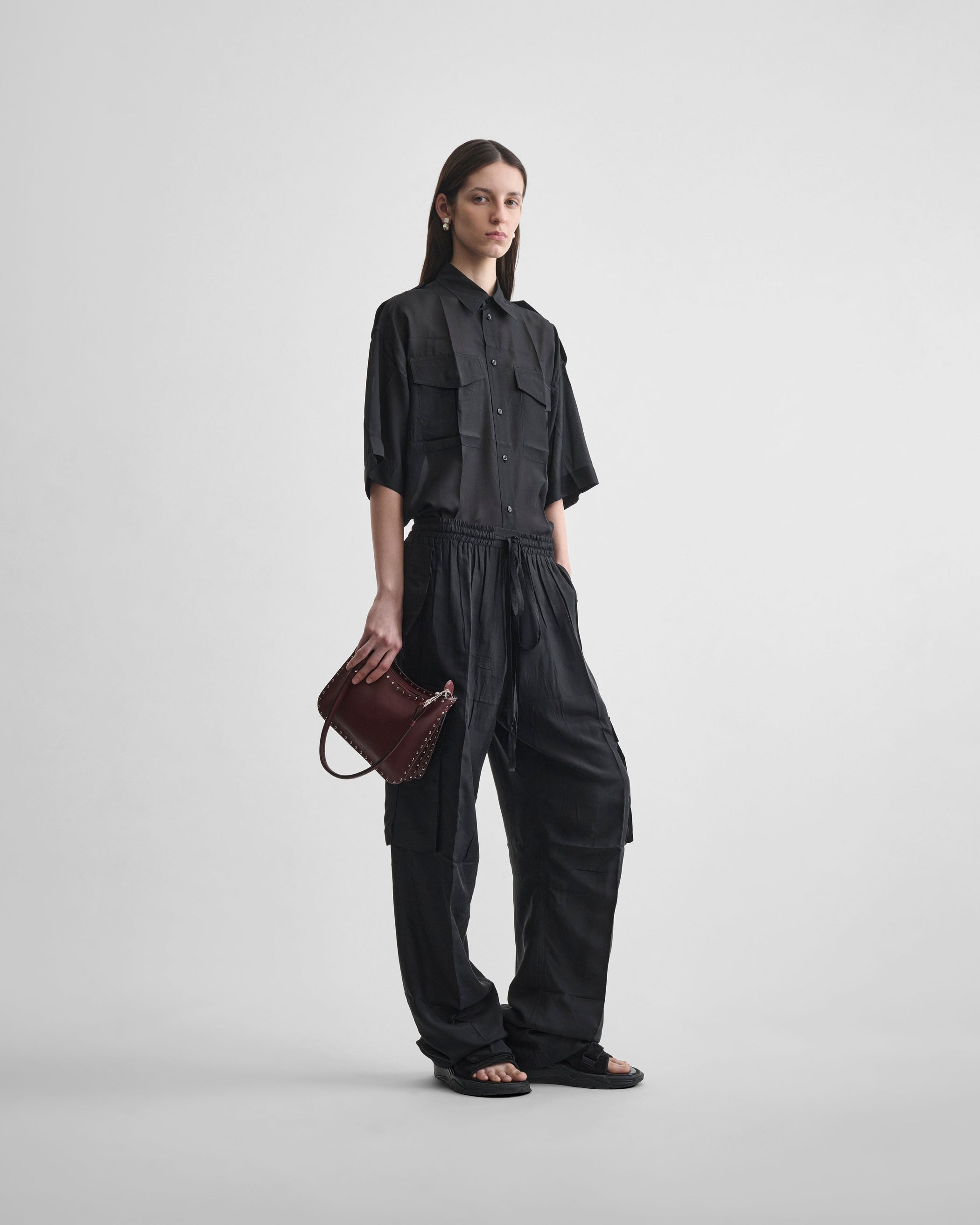 Front view of model wearing CARGO TROUSERS in black silk