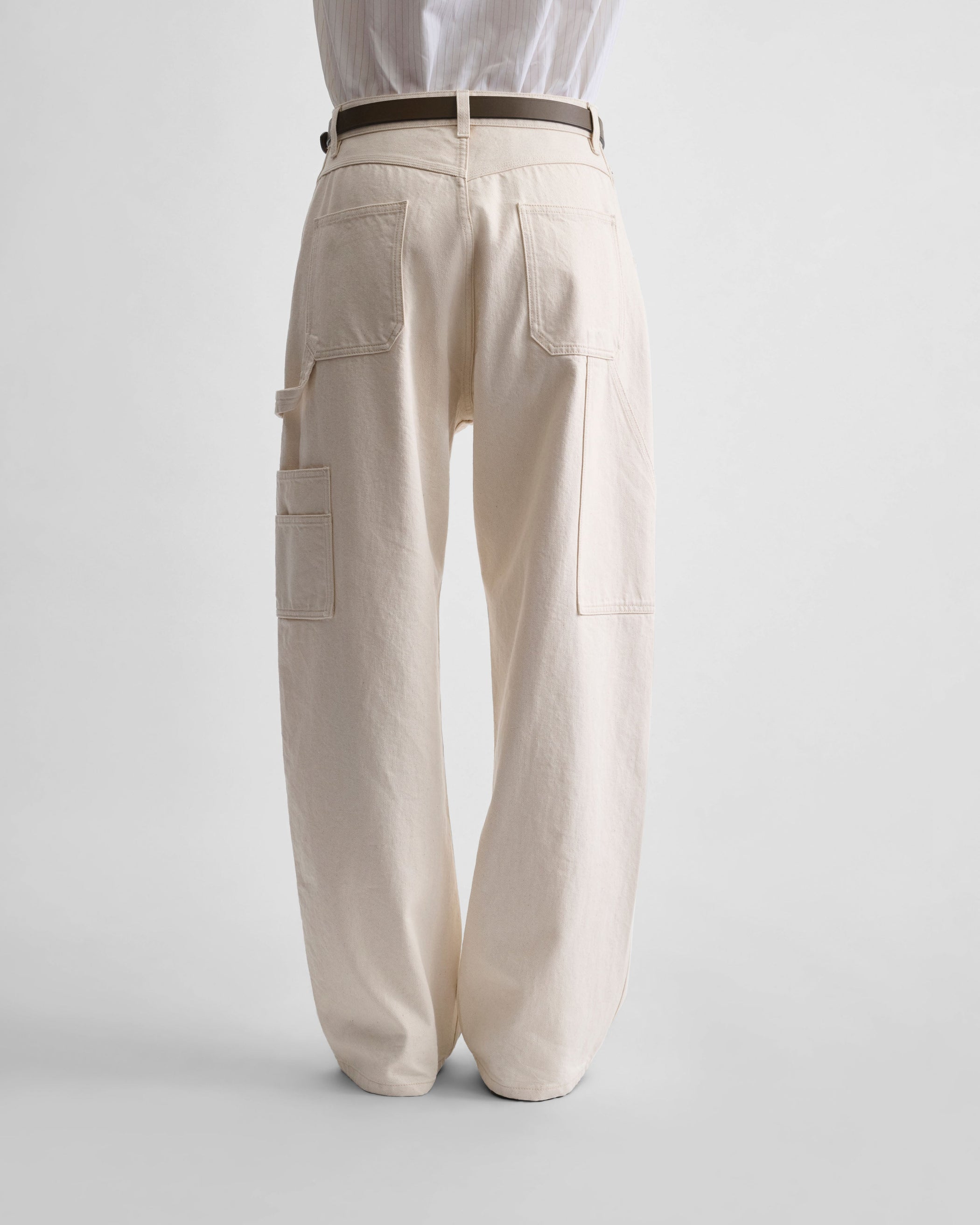 back view of model wearing CARPENTER JEANS in cream cotton