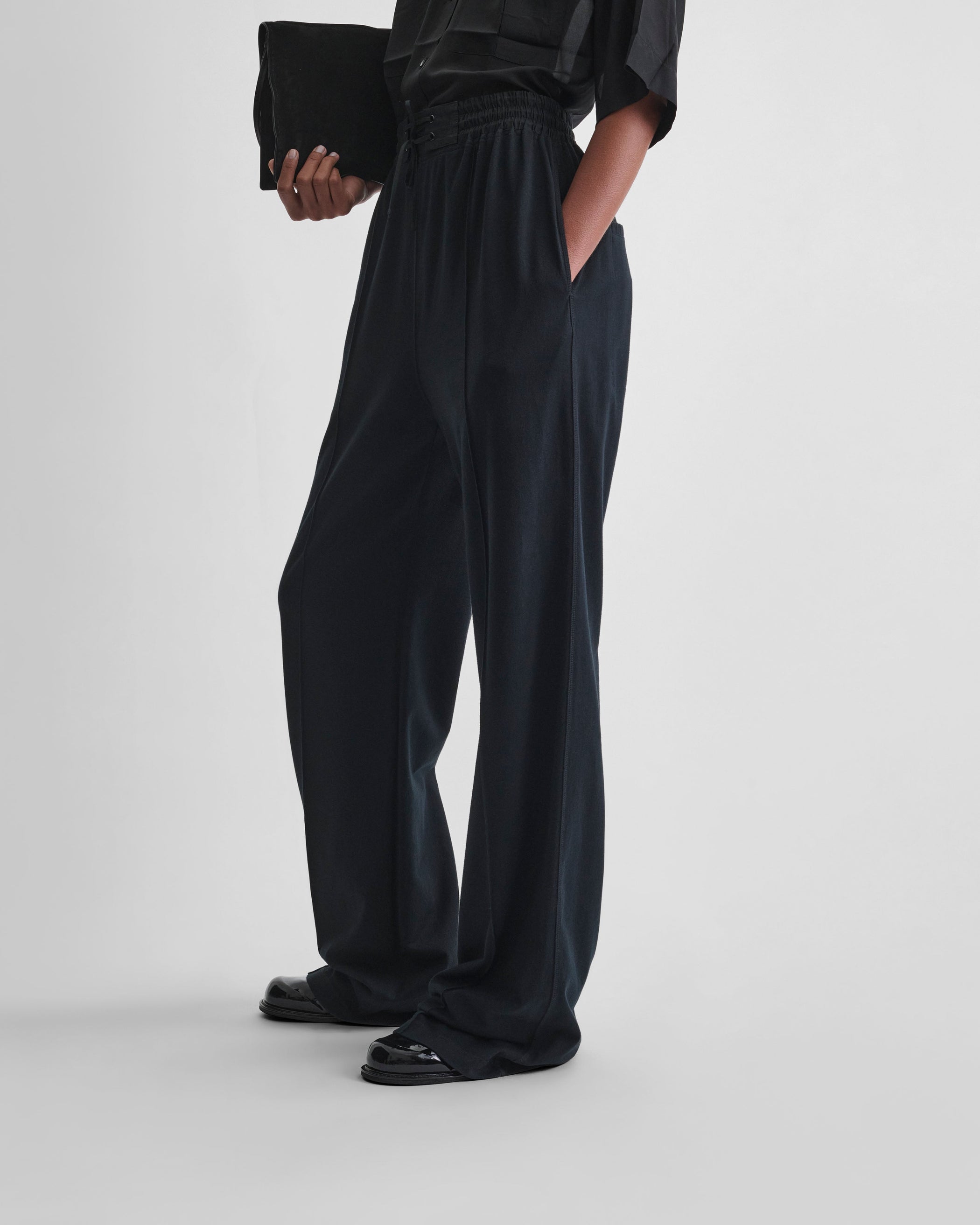 Side view of model wearing JOGGER in black jersey