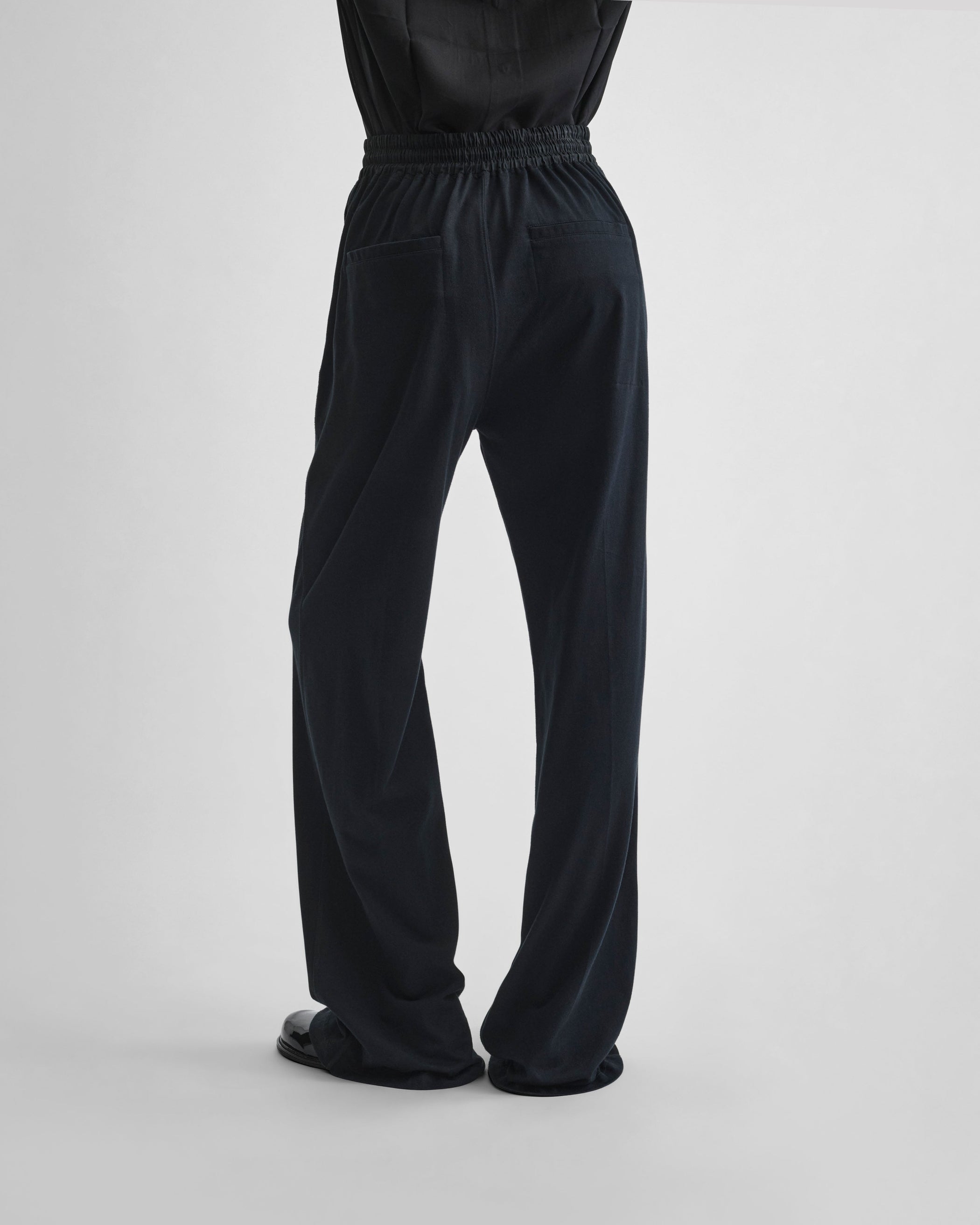 Back view of model wearing JOGGER in black jersey