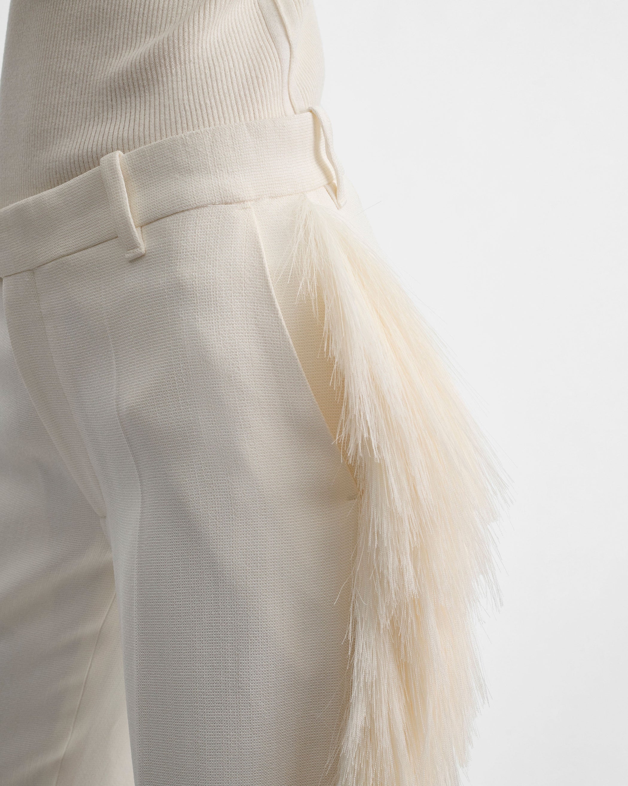 Detail view of model wearing FRINGED TROUSERS in vanilla viscose