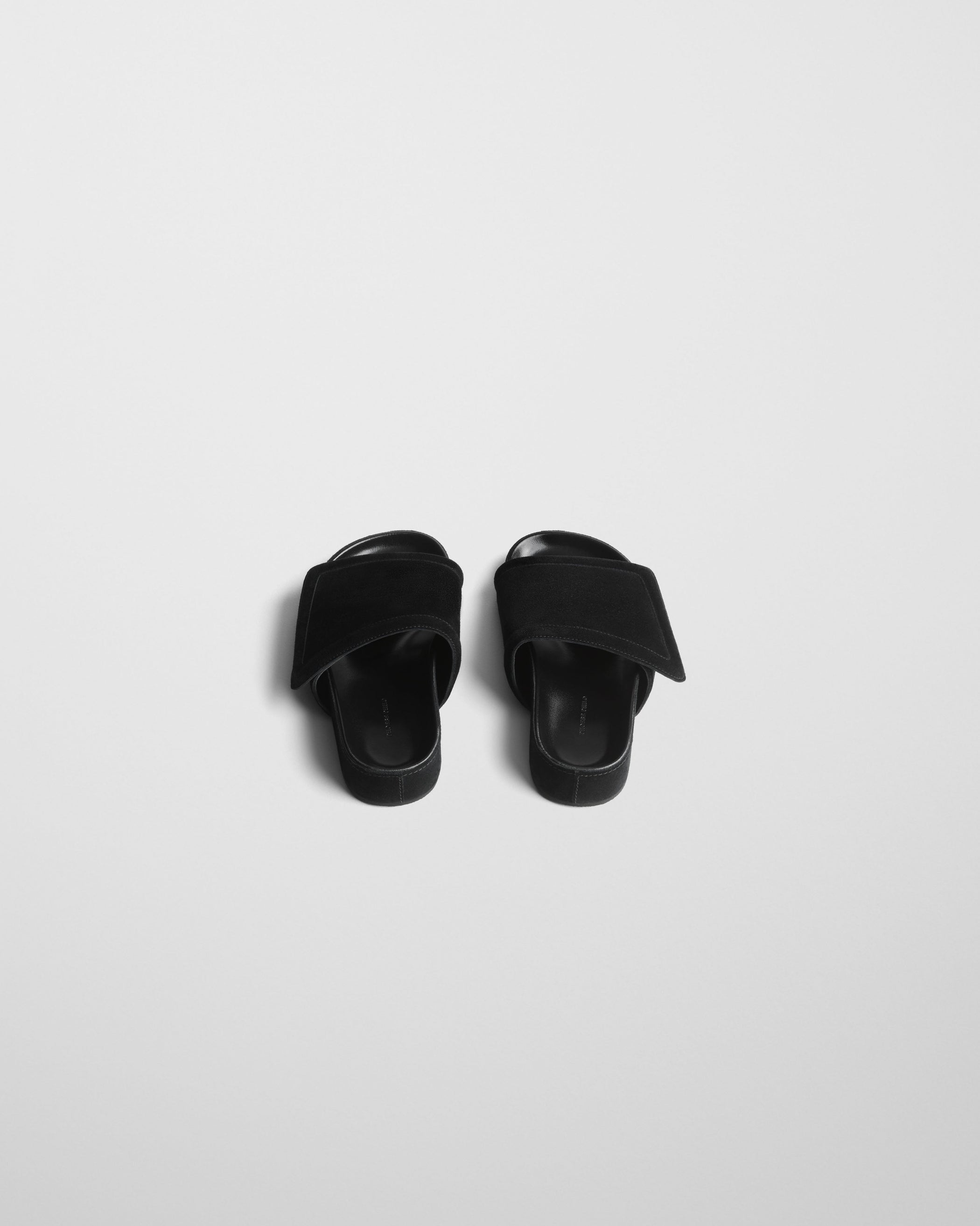 Angled top view of WIDE SLIDE in black suede