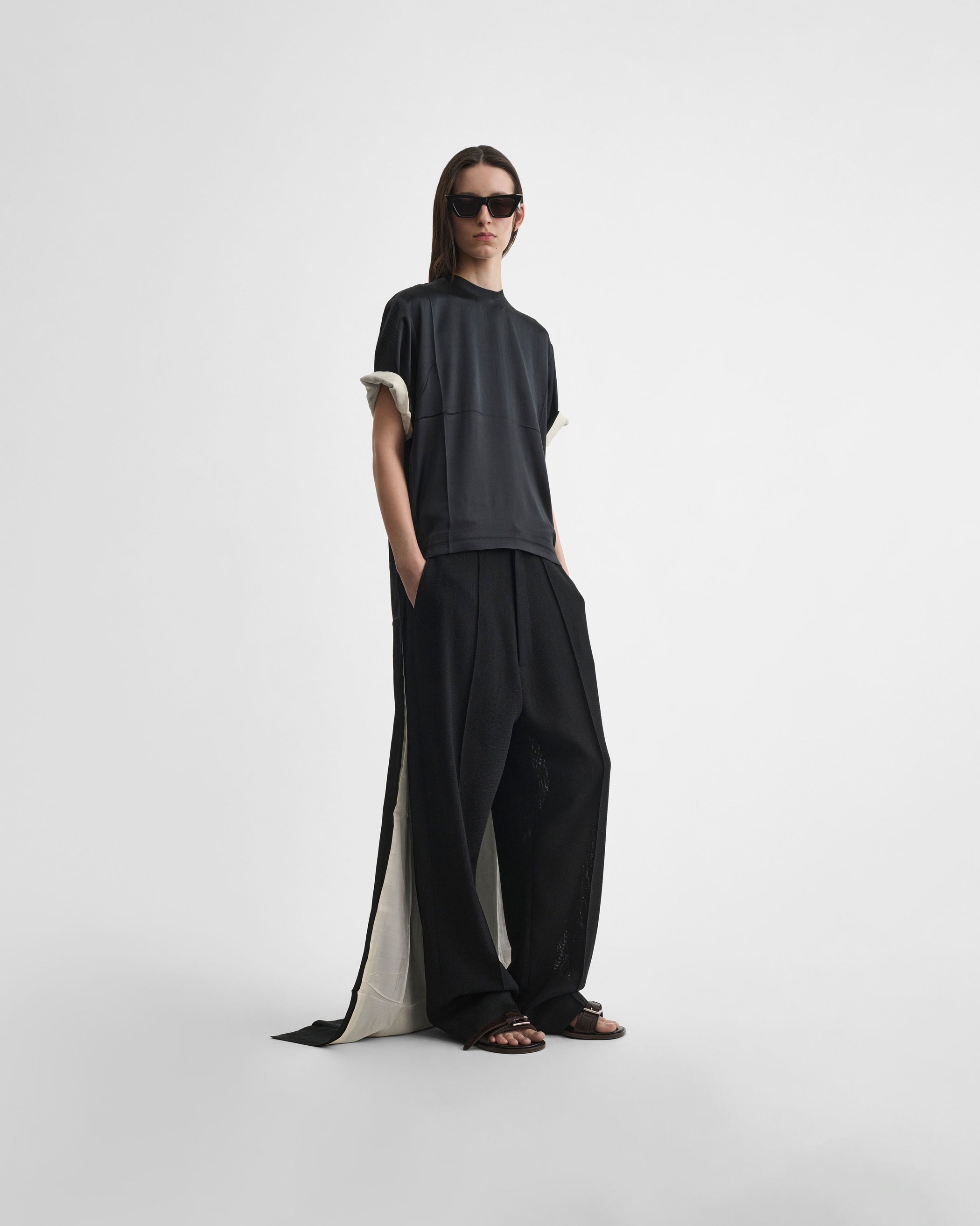 Front view of model wearing GRAPHIC TRAIN TEE in black silk