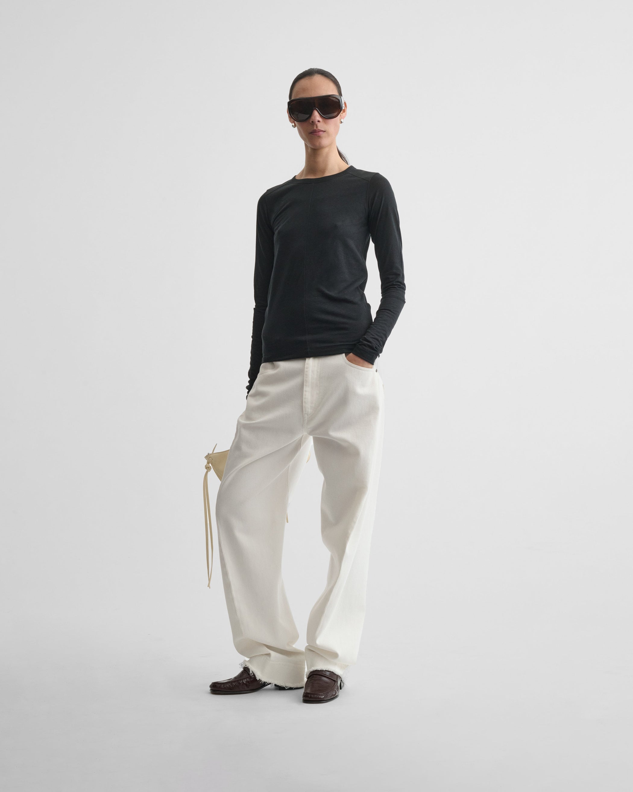 Front view of model wearing CREW NECK TOP in black cotton