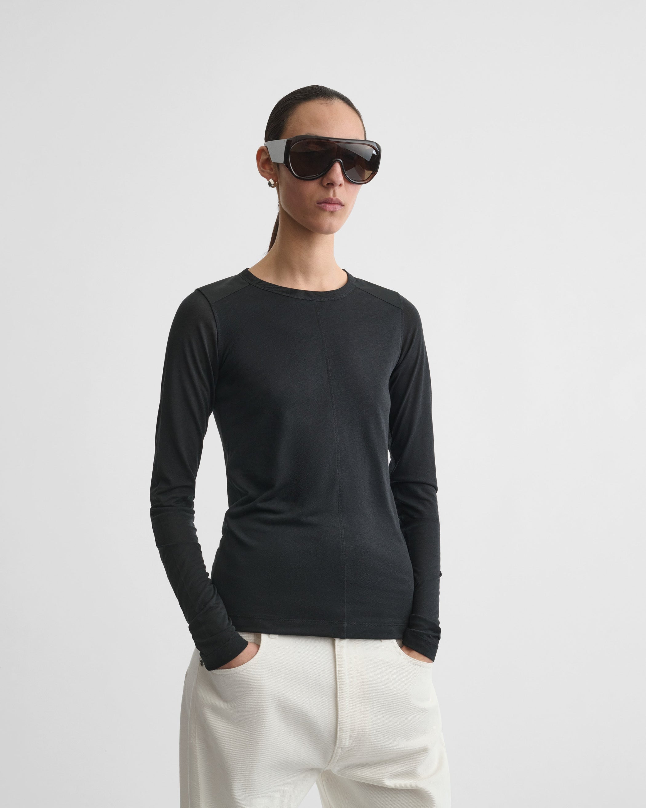 Front view of model wearing CREW NECK TOP in black cotton