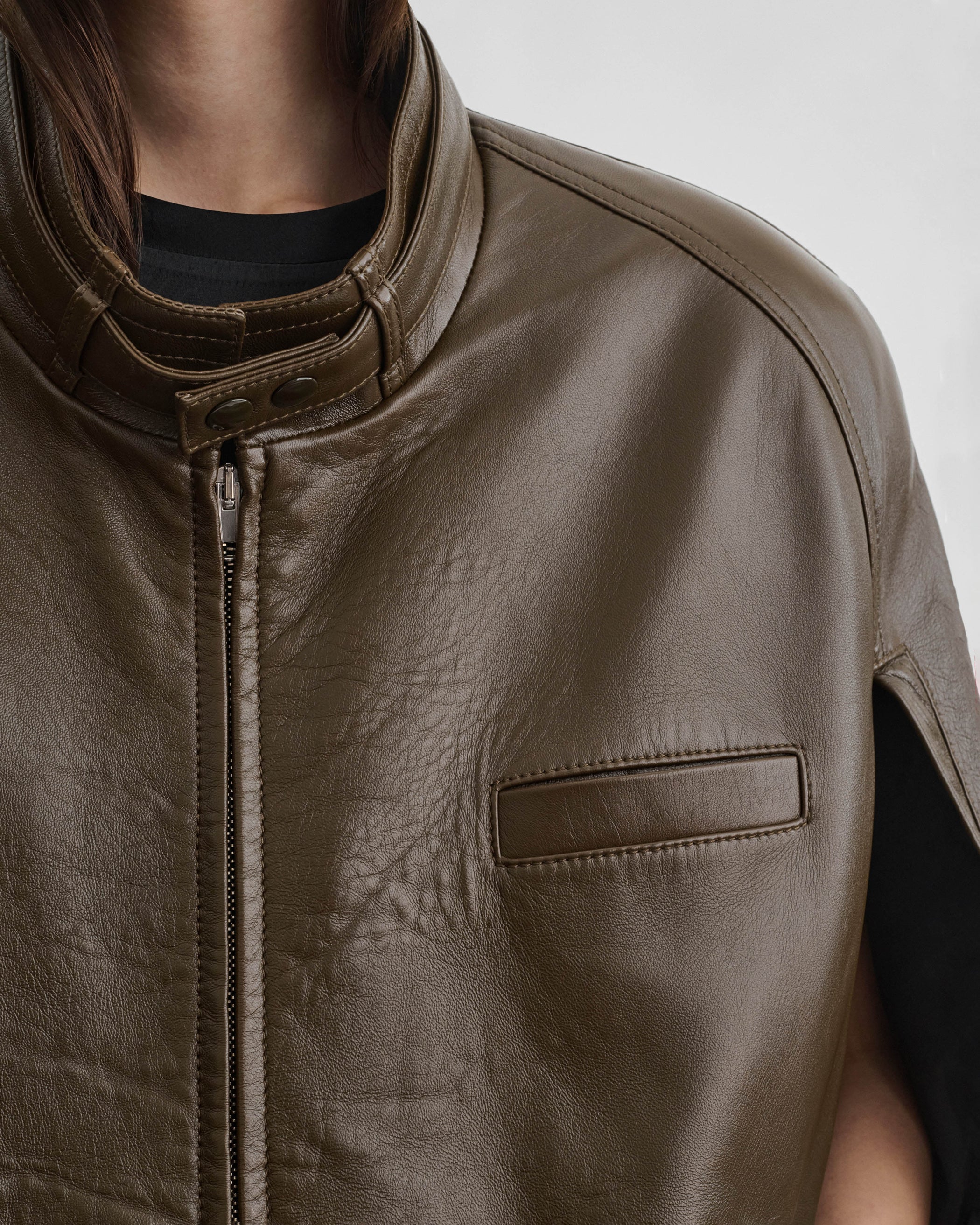 Front detail view of model wearing CAPE BOMBER in green bronze leather