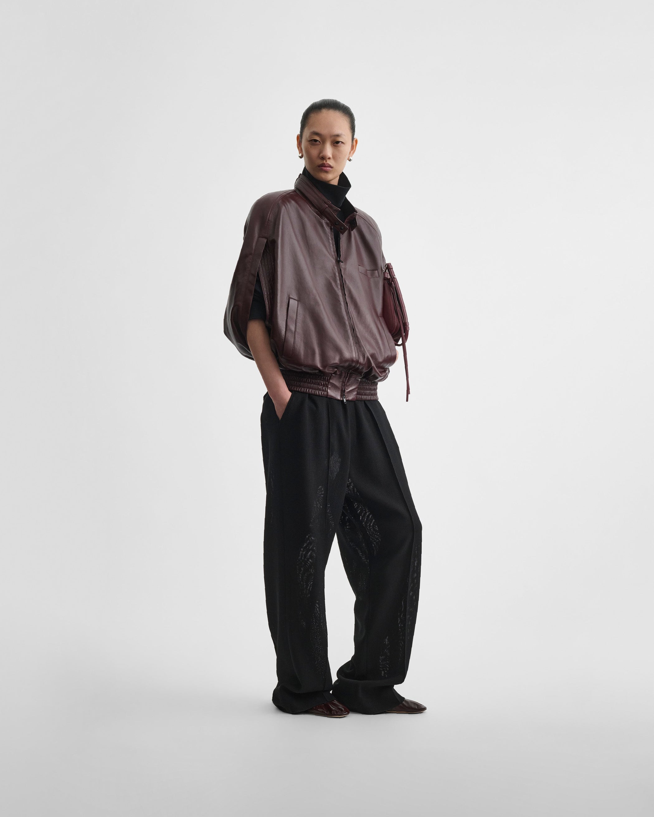 Front view of model wearing CAPE BOMBER in merlot leather