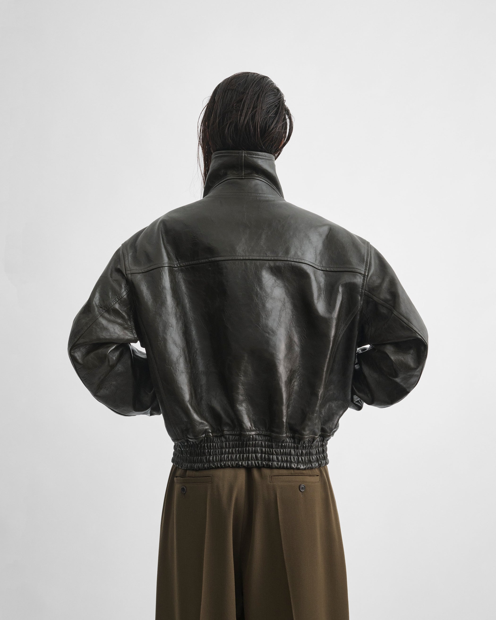 Back close up model view of model wearing the AVIATOR JACKET in dark emerald leather