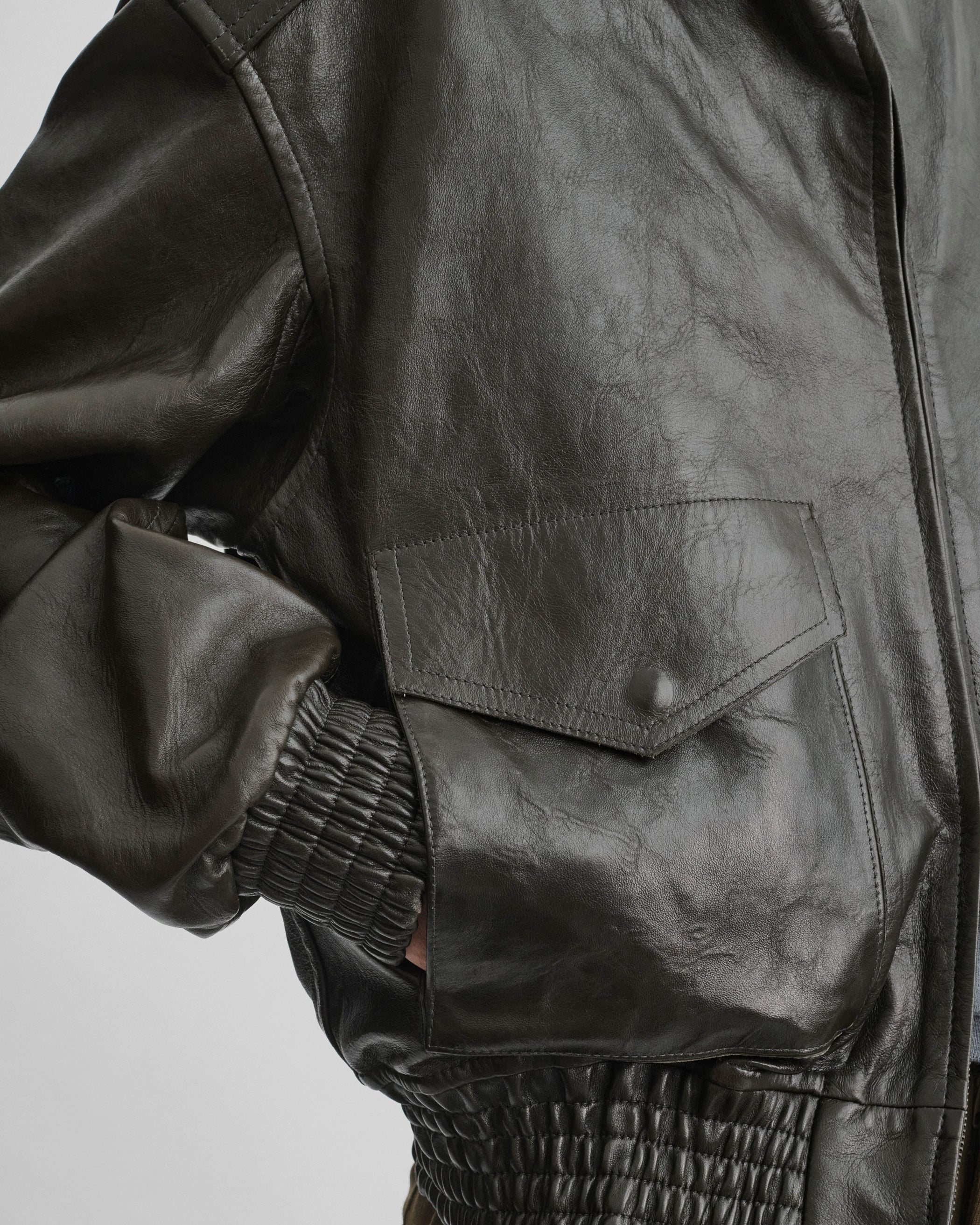 Close up detail view of model wearing the AVIATOR JACKET in dark emerald leather