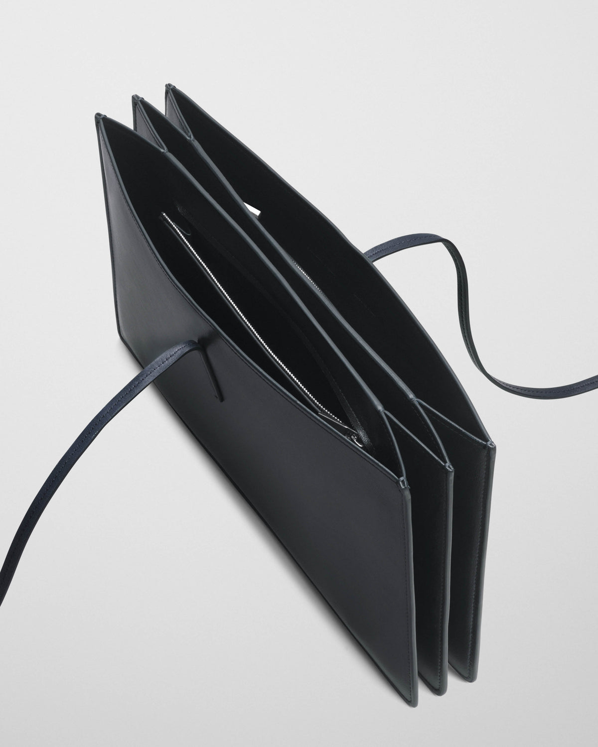 Detail view of SPLAY CLUTCH in dark navy leather