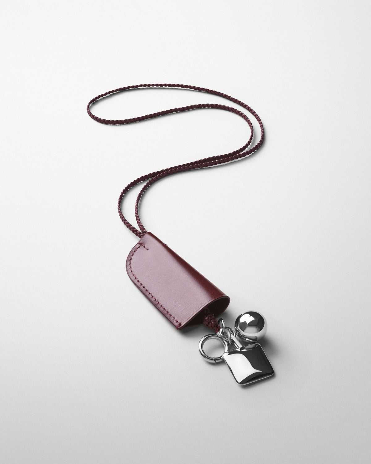 Detail view of GLOVE LANYARD in crimson leather