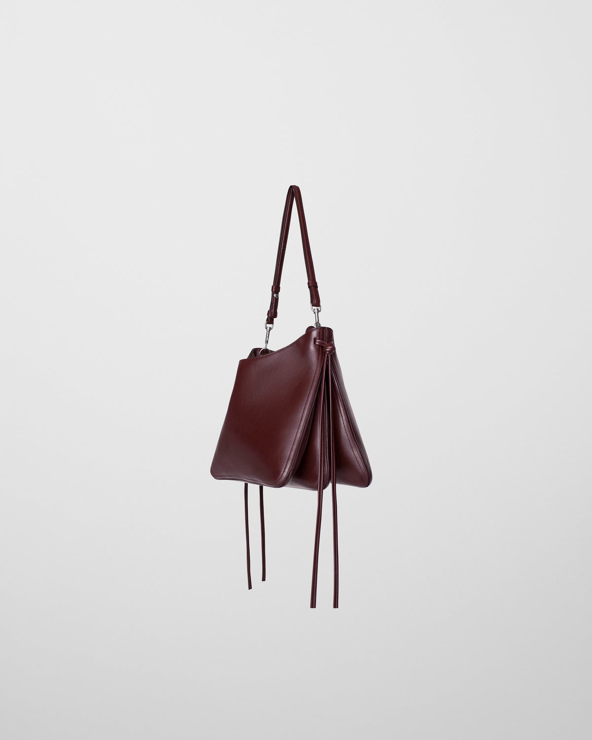 Angled side view of GIG BAG in oxblood leather