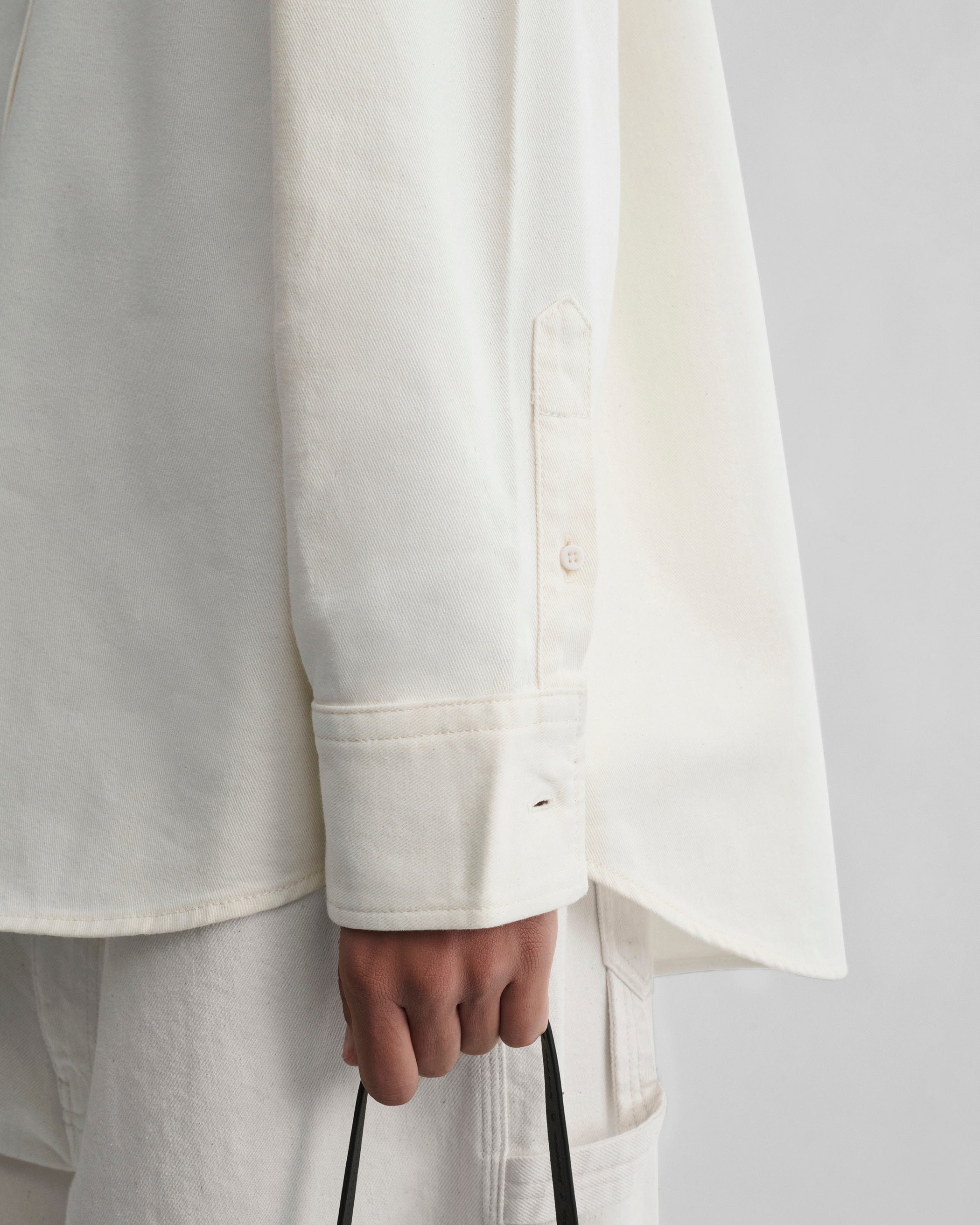 Detail sleeve view of model wearing DENIM SHIRT in chalk cotton