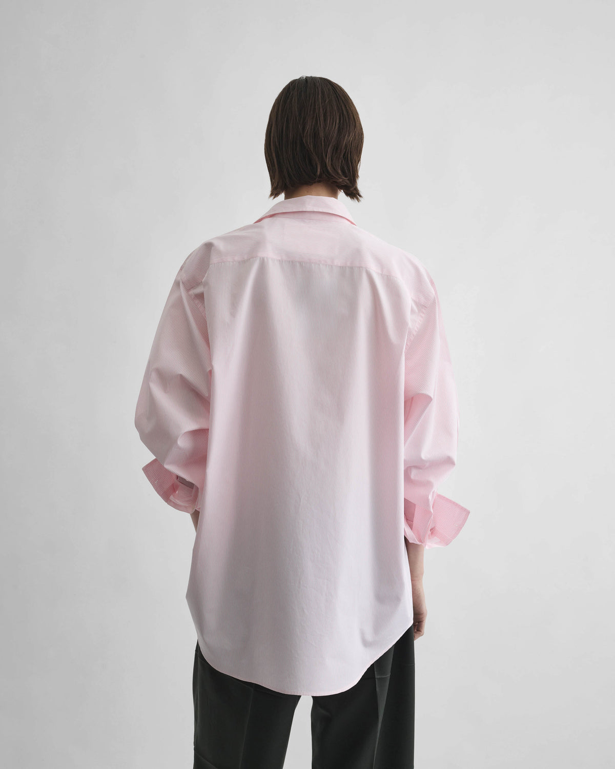 Back view of model wearing MEN'S SHIRT in pink cotton