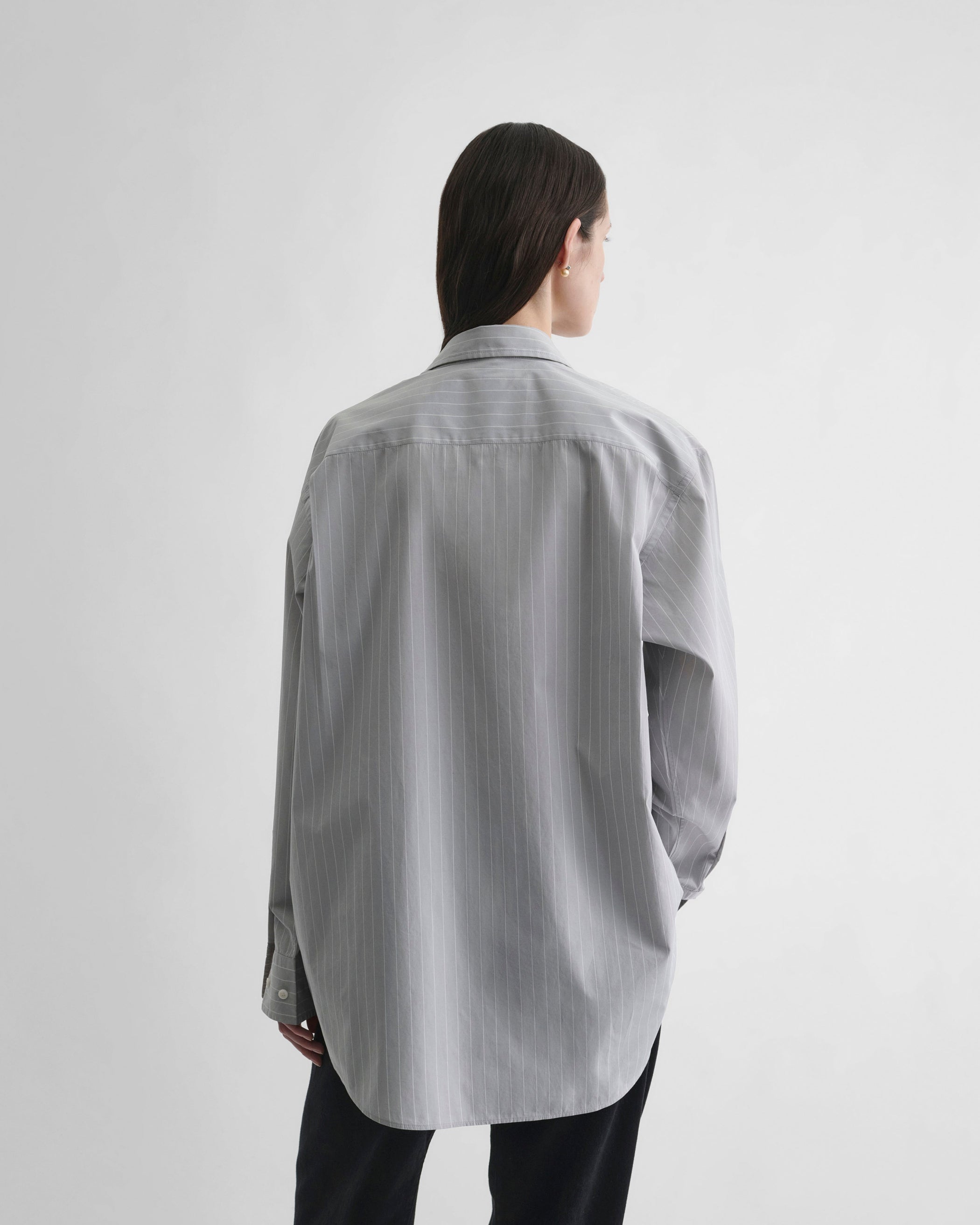 Back view of model wearing MEN'S SHIRT in soft grey cotton