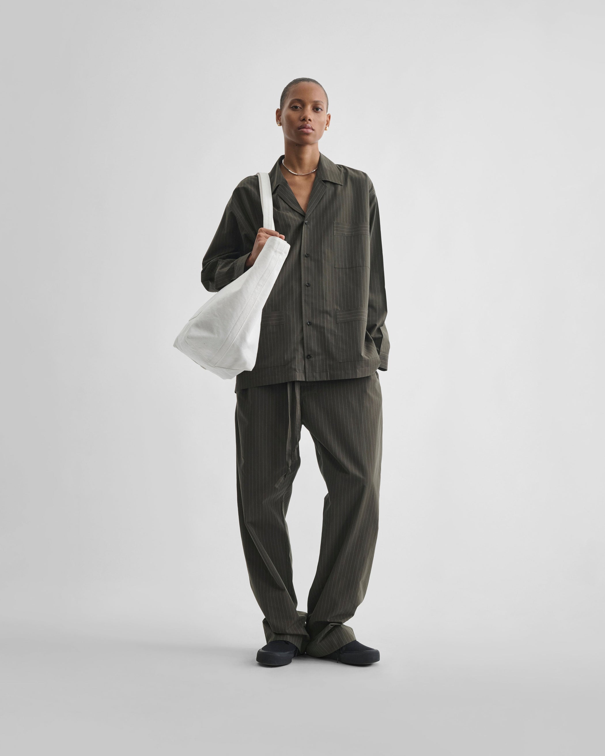 Front view of model wearing PYJAMA SHIRT in dark khaki cotton