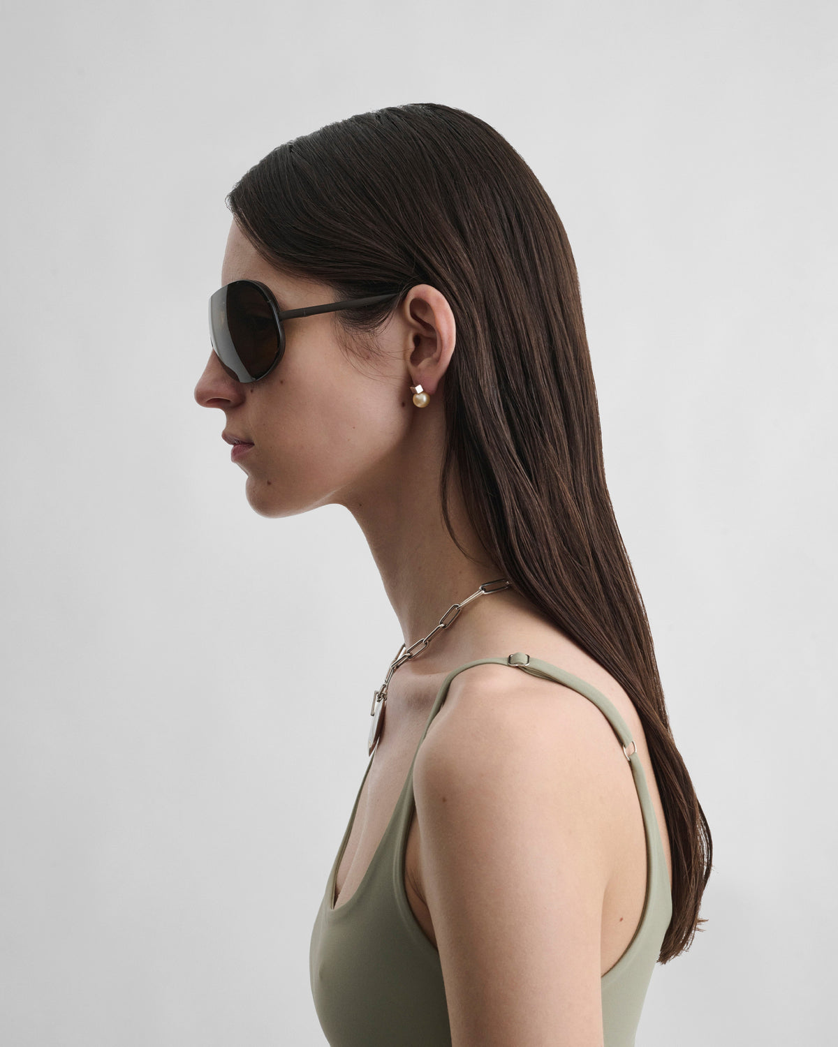 Side view of model wearing BEAM SUNGLASSES in khaki metal