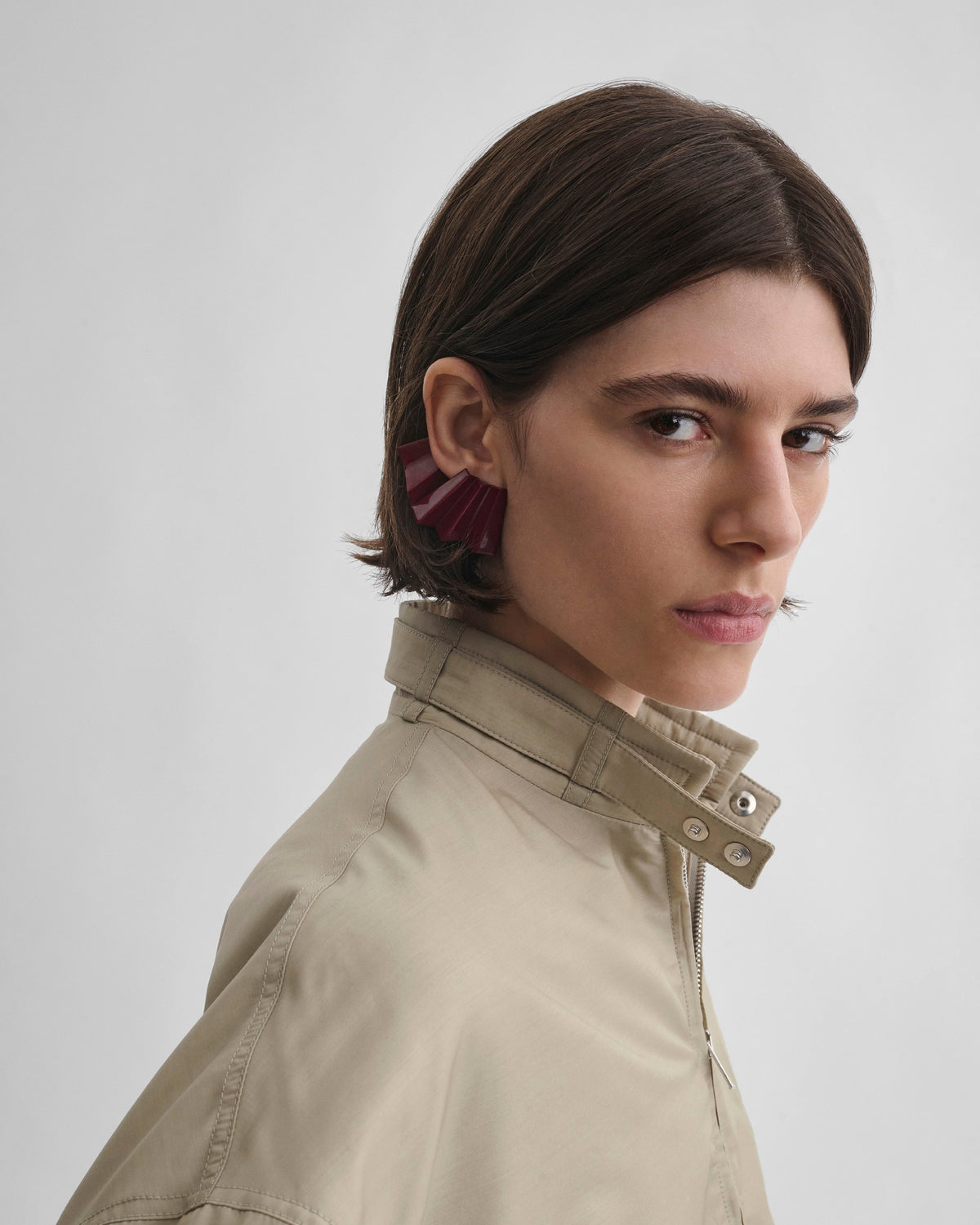 Front view of model wearing PLEATED EARRING in oxblood enamel