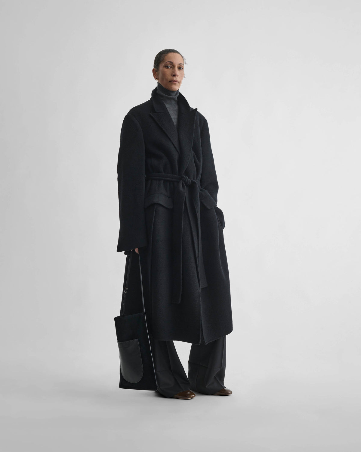 Front view of model wearing BELTED ROVE COAT in black cashmere