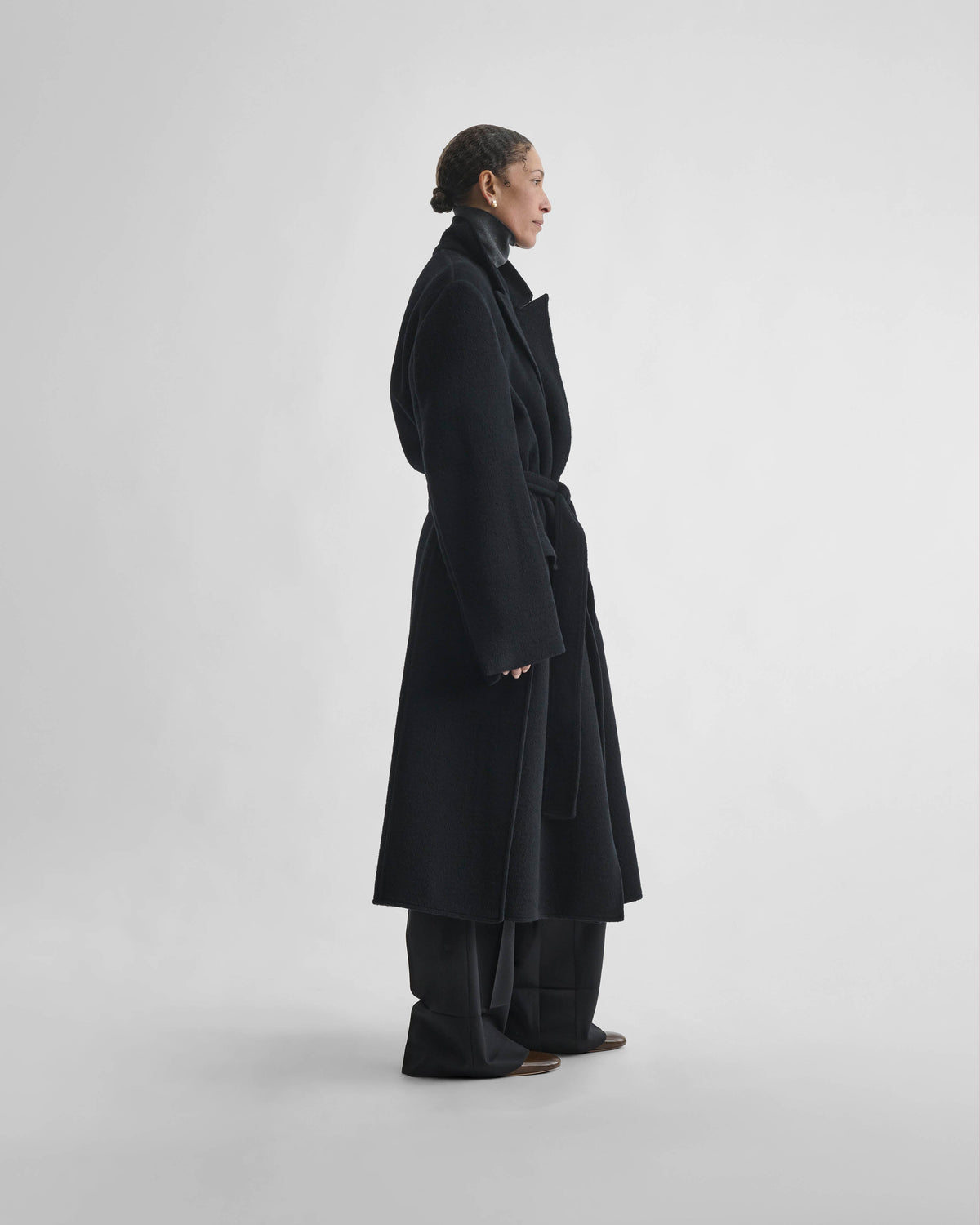 Side view of model wearing BELTED ROBE COAT in black cashmere
