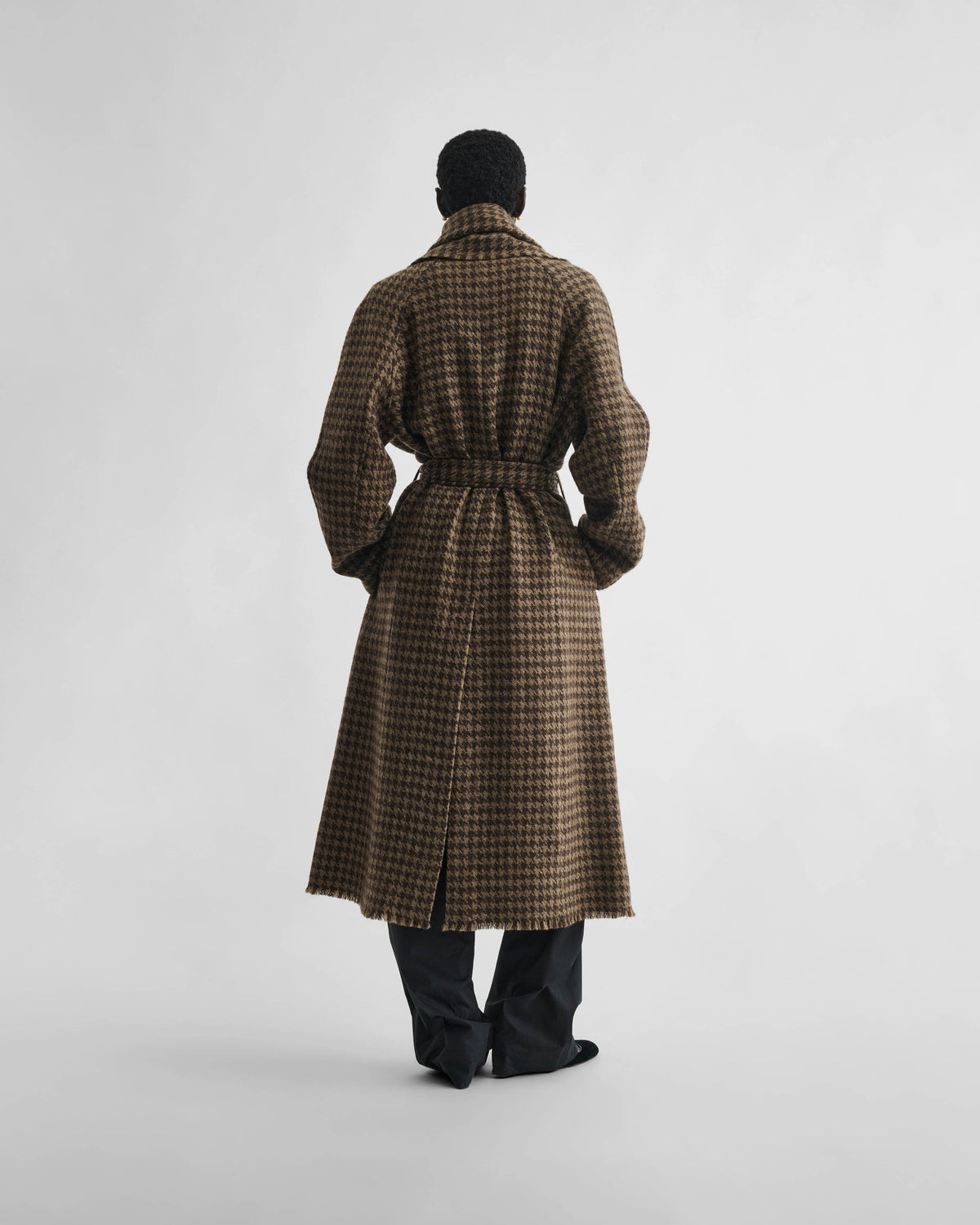 Back view of model wearing BLANKET COAT in brown bronze wool