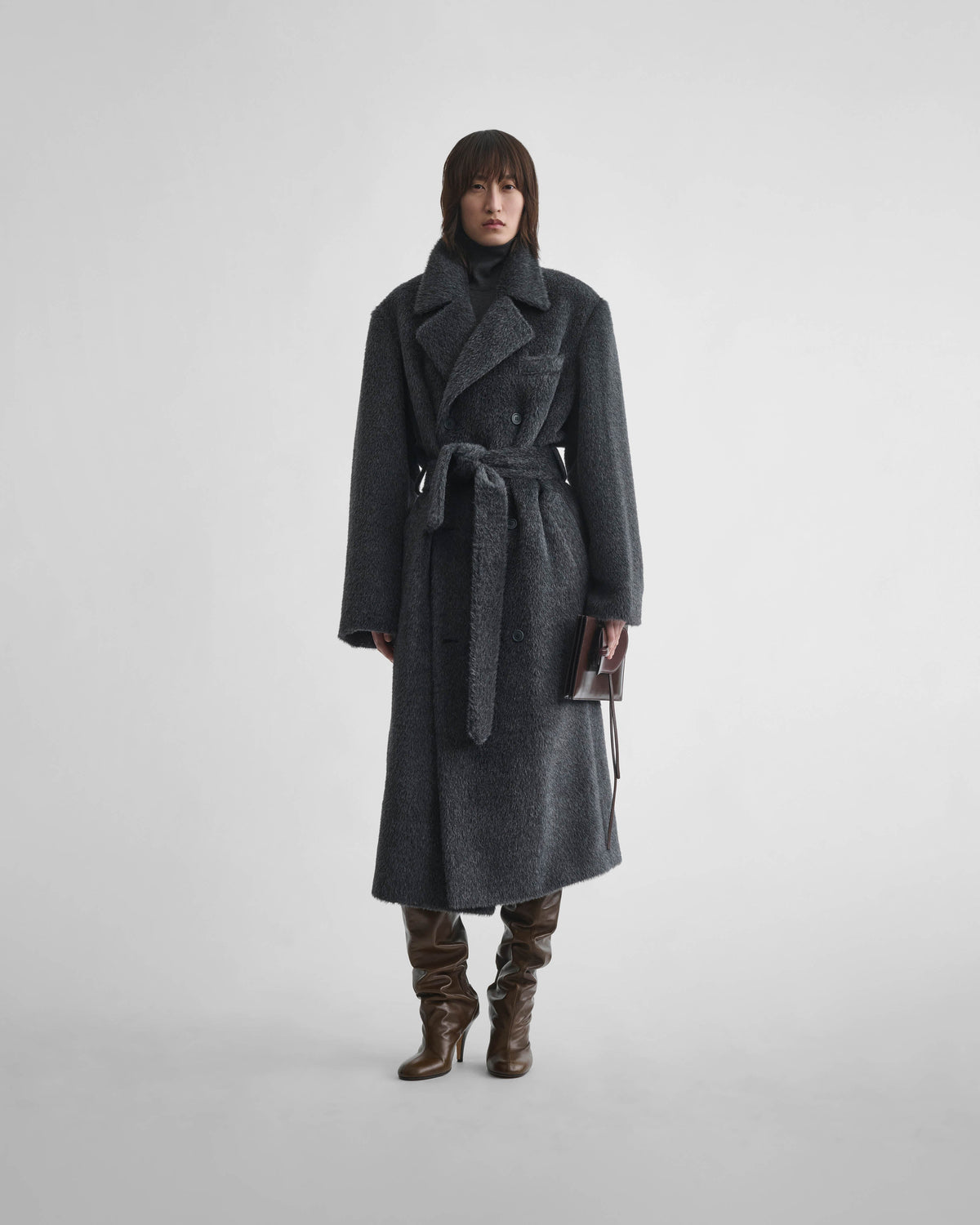 Front view of model wearing BELTED TEDDY COAT in ash shearling