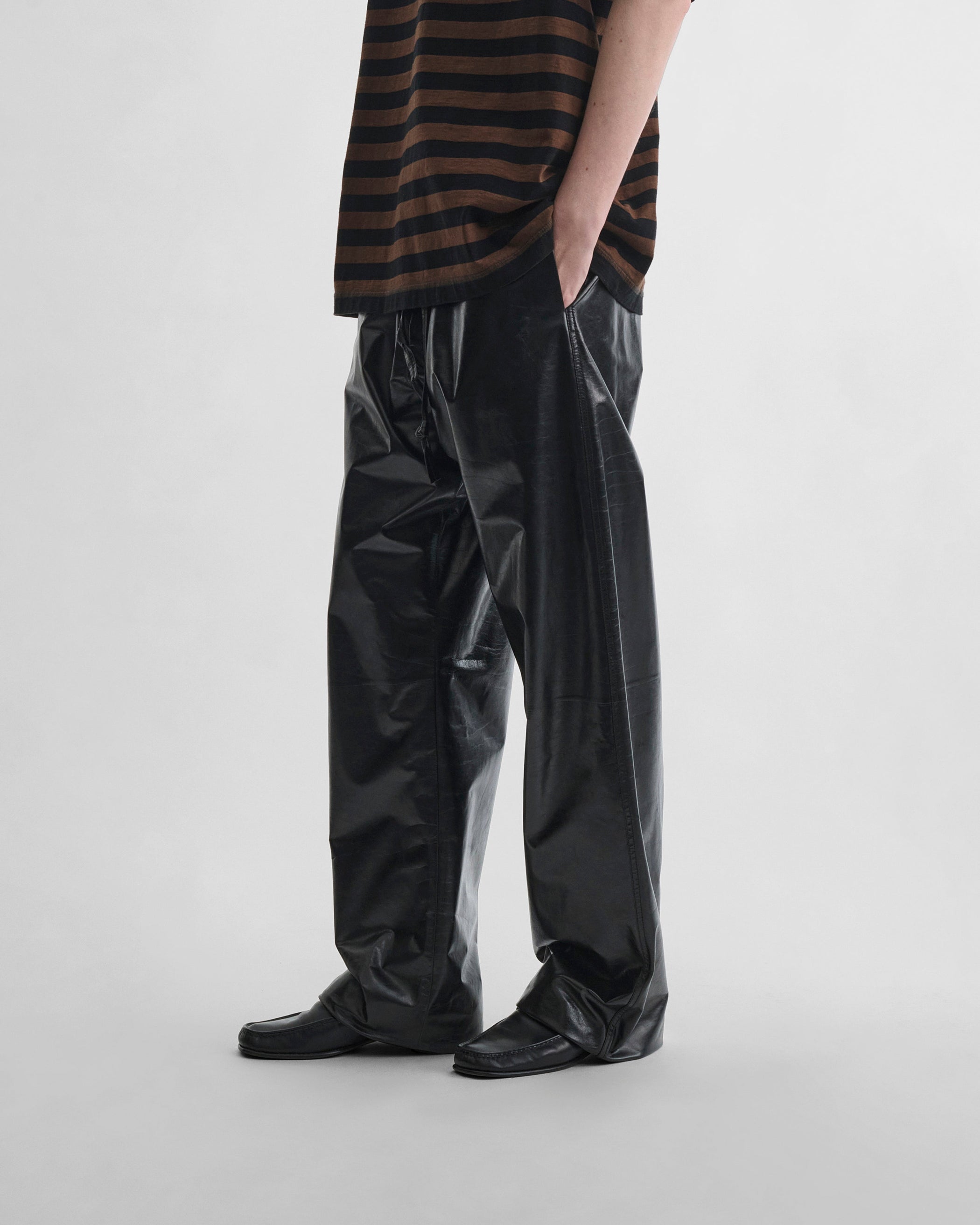 Side view of model PYJAMA TROUSERS in black leather