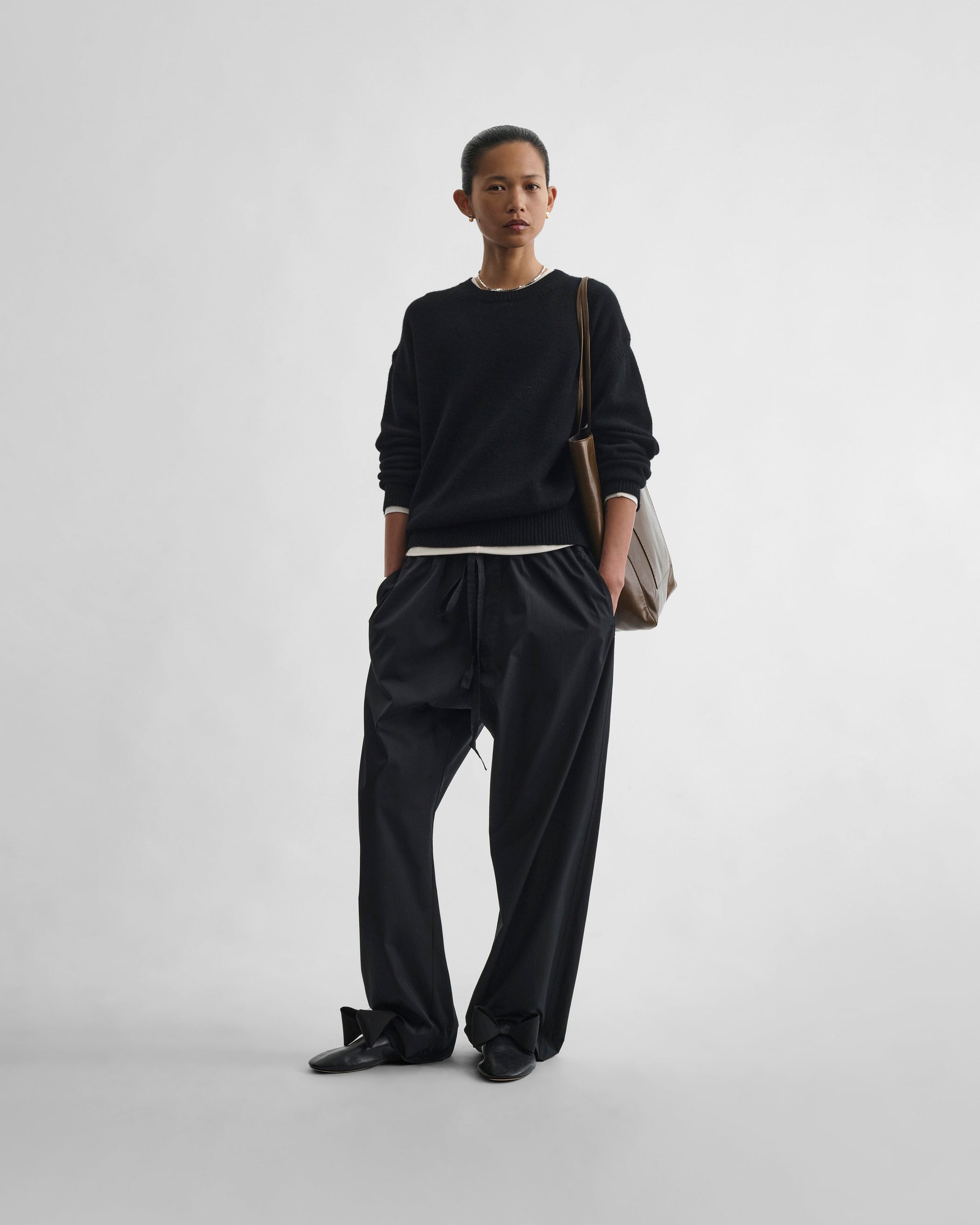Front view of model wearing PYJAMA TROUSERS in black cotton